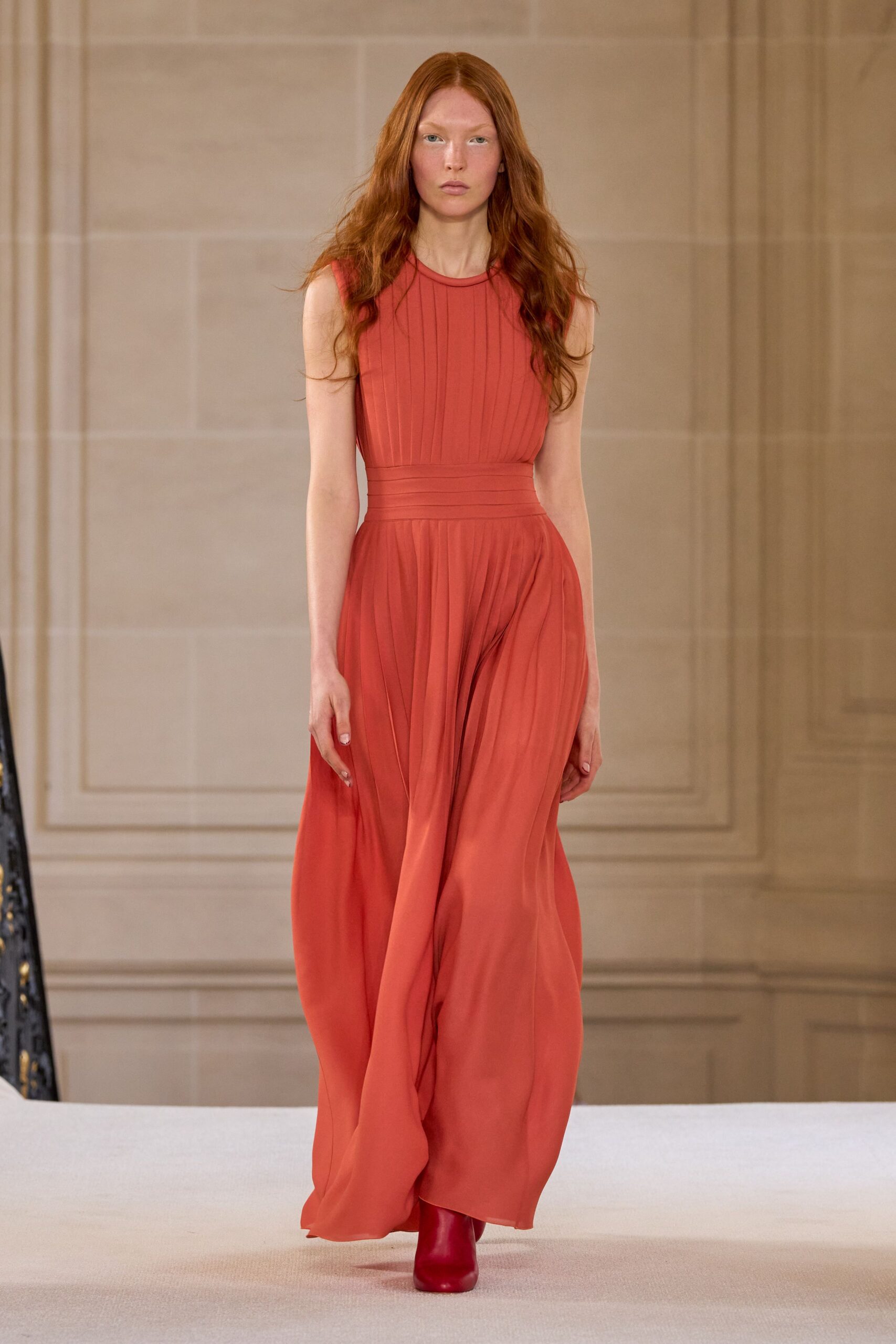 red silk sleeveless high-neck fitted pleated flowing gown