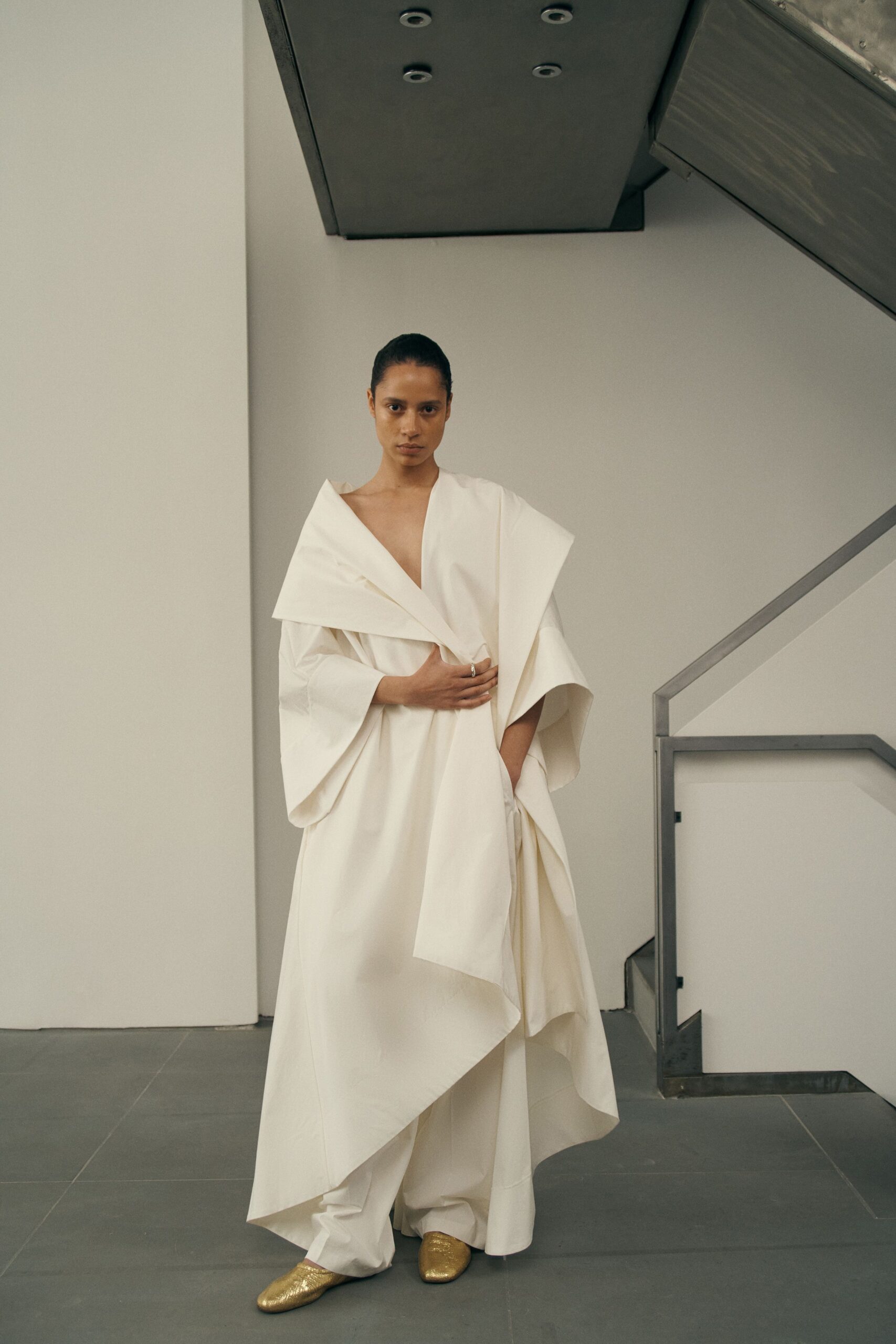 white layered gown with gold shoes