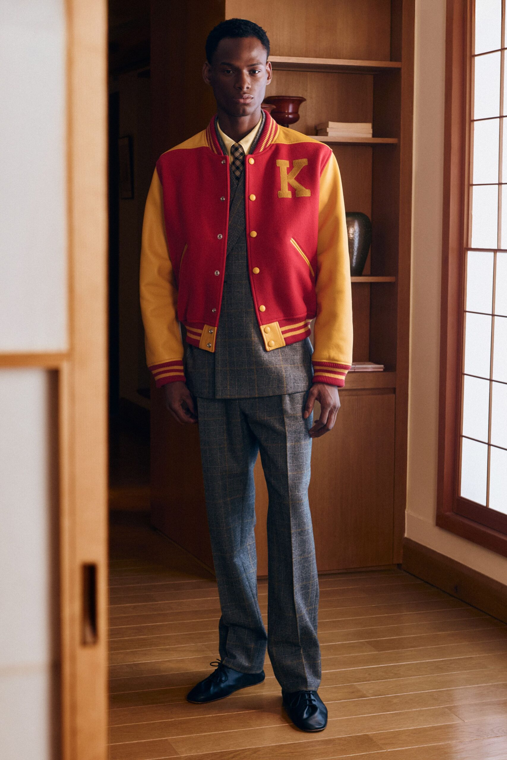 red and yellow varsity jacket with gray pants