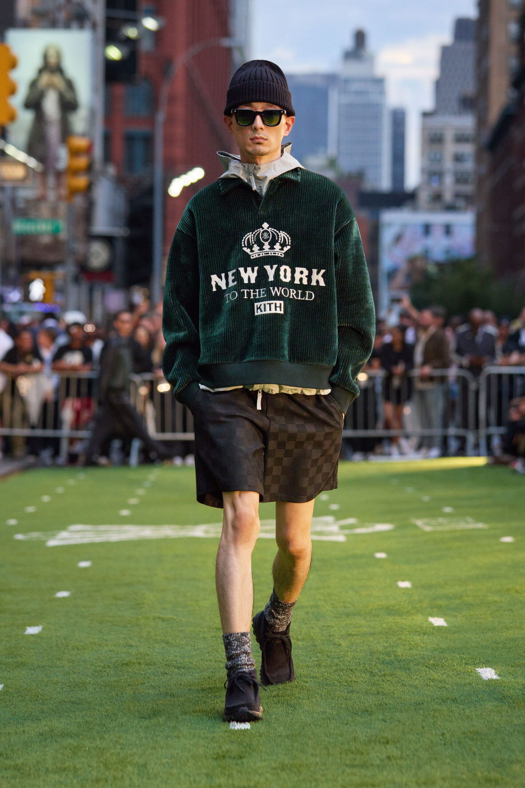 green relaxed sweater with black shorts