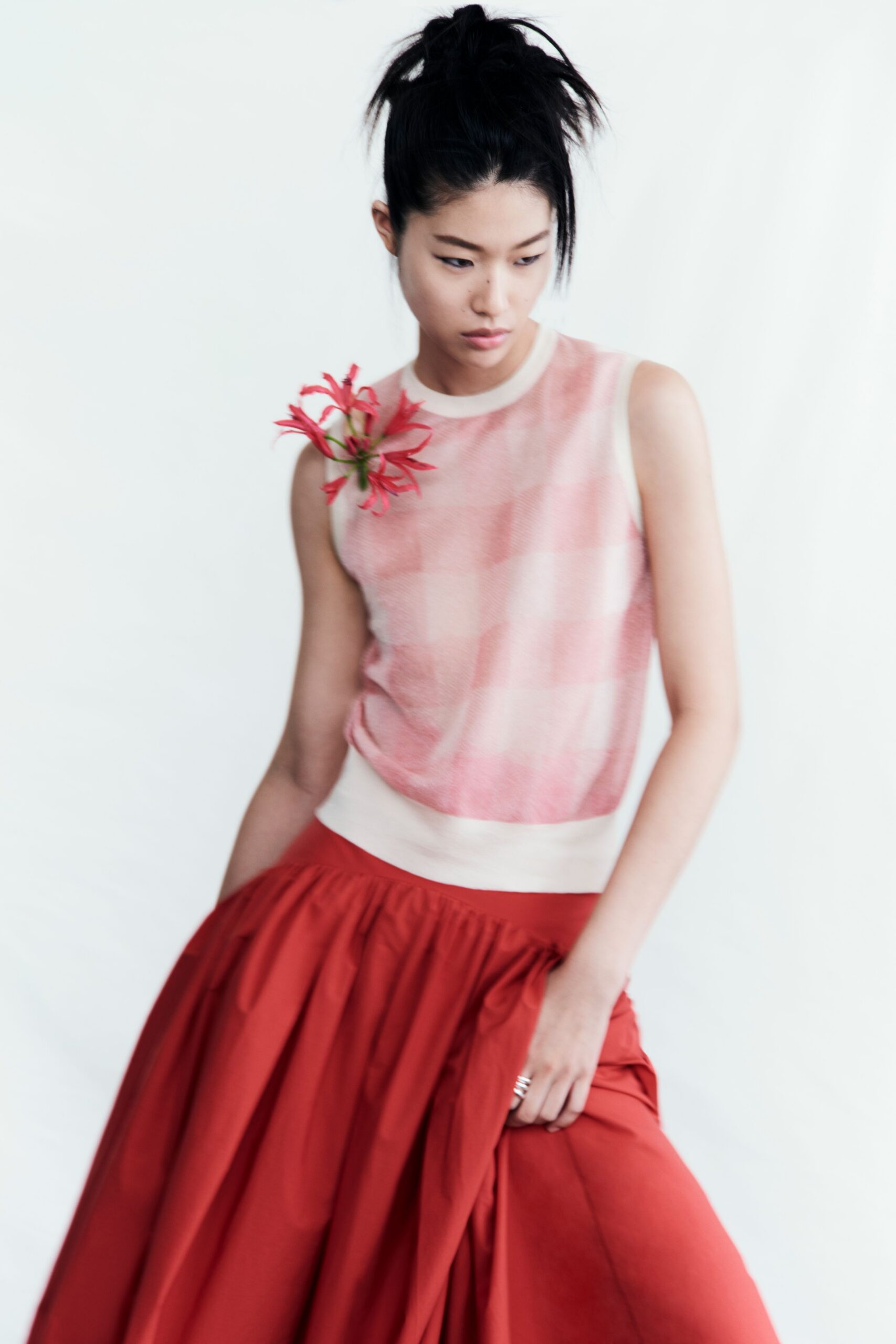 pink checked top and red pleated skirt