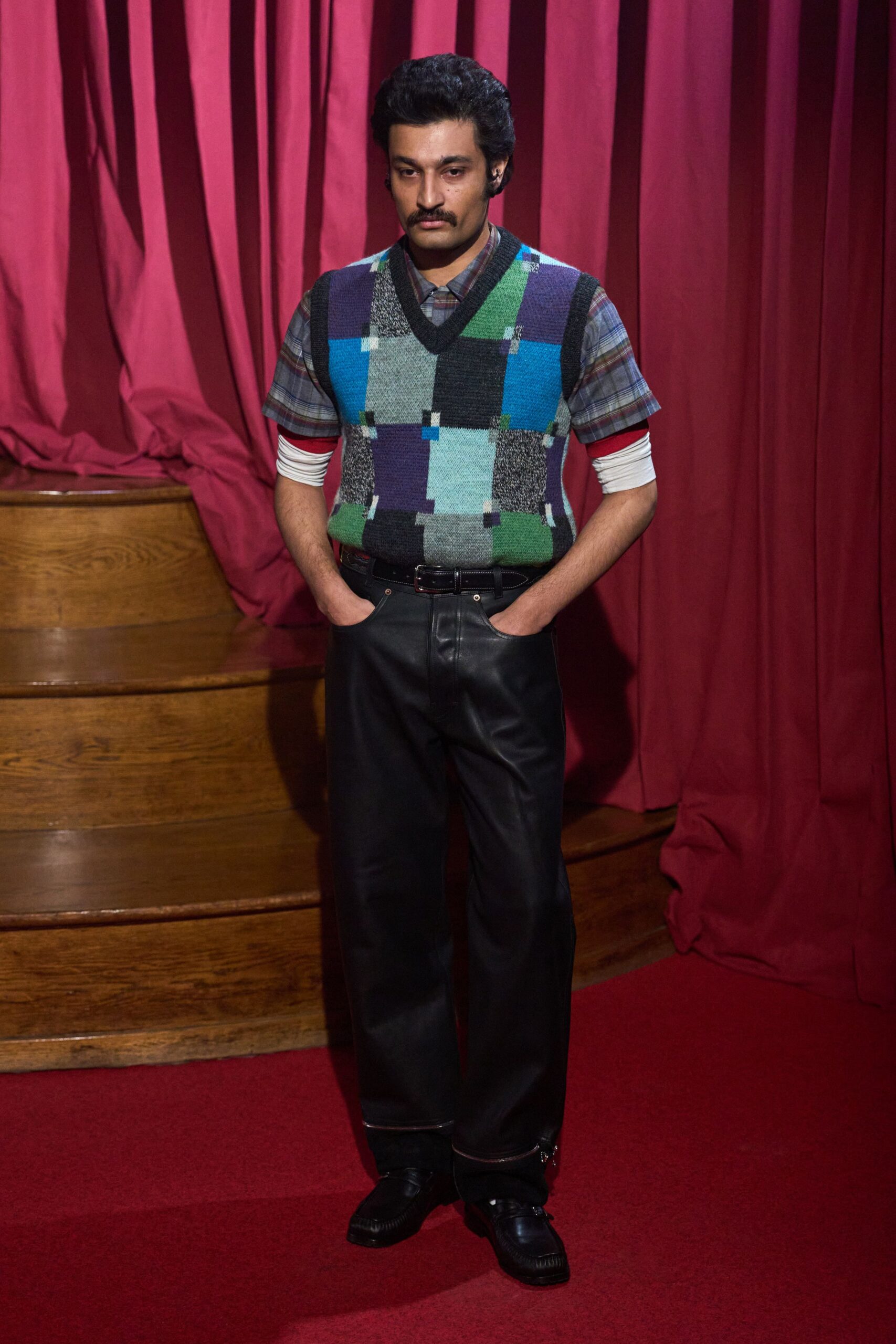 checked sweater with leather pants
