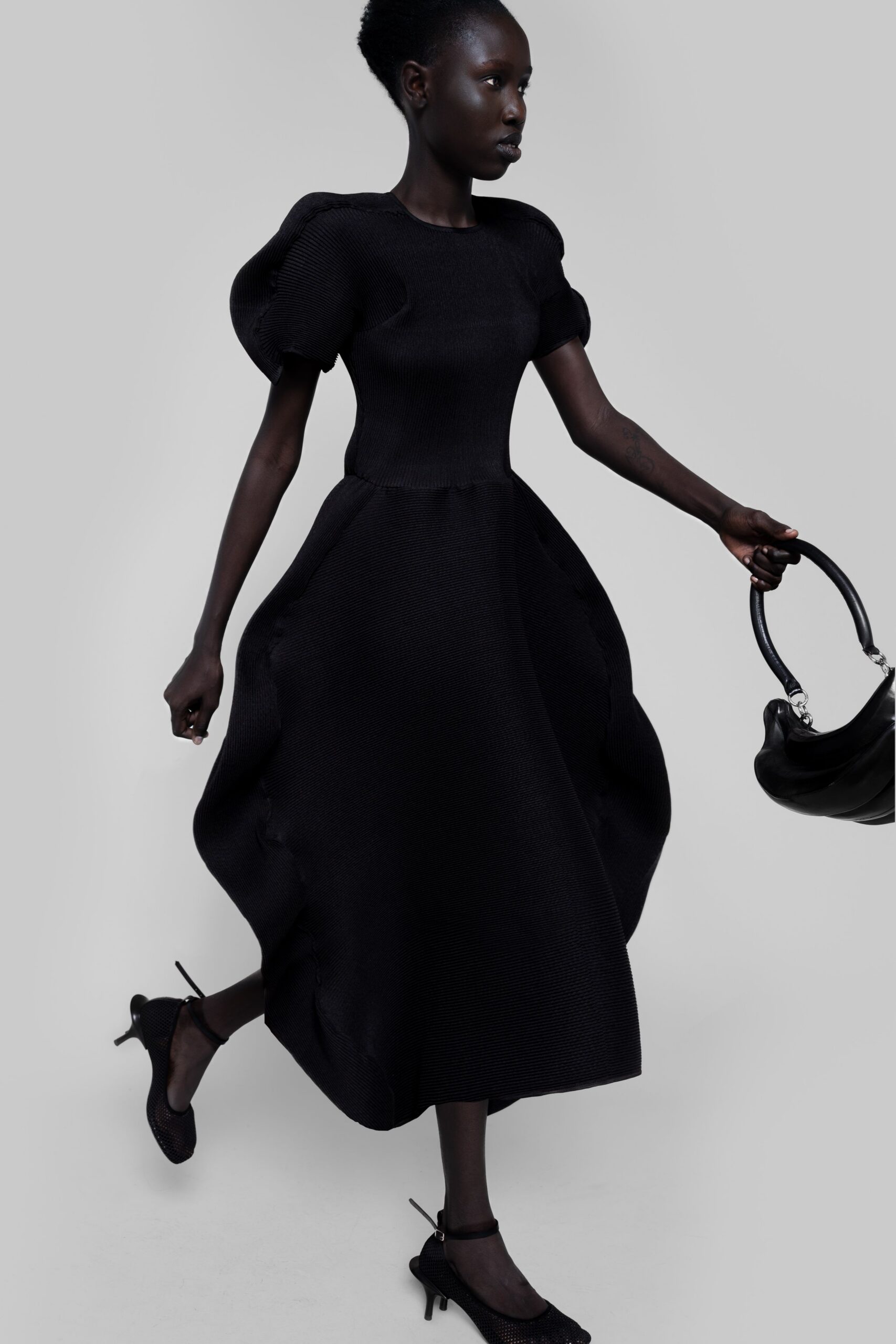 black midi dress with structured bag