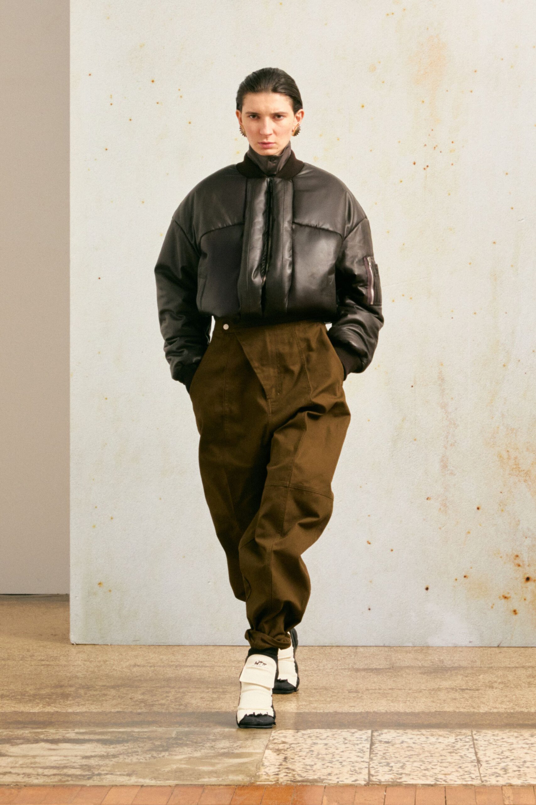 black leather relaxed jacket with brown pants