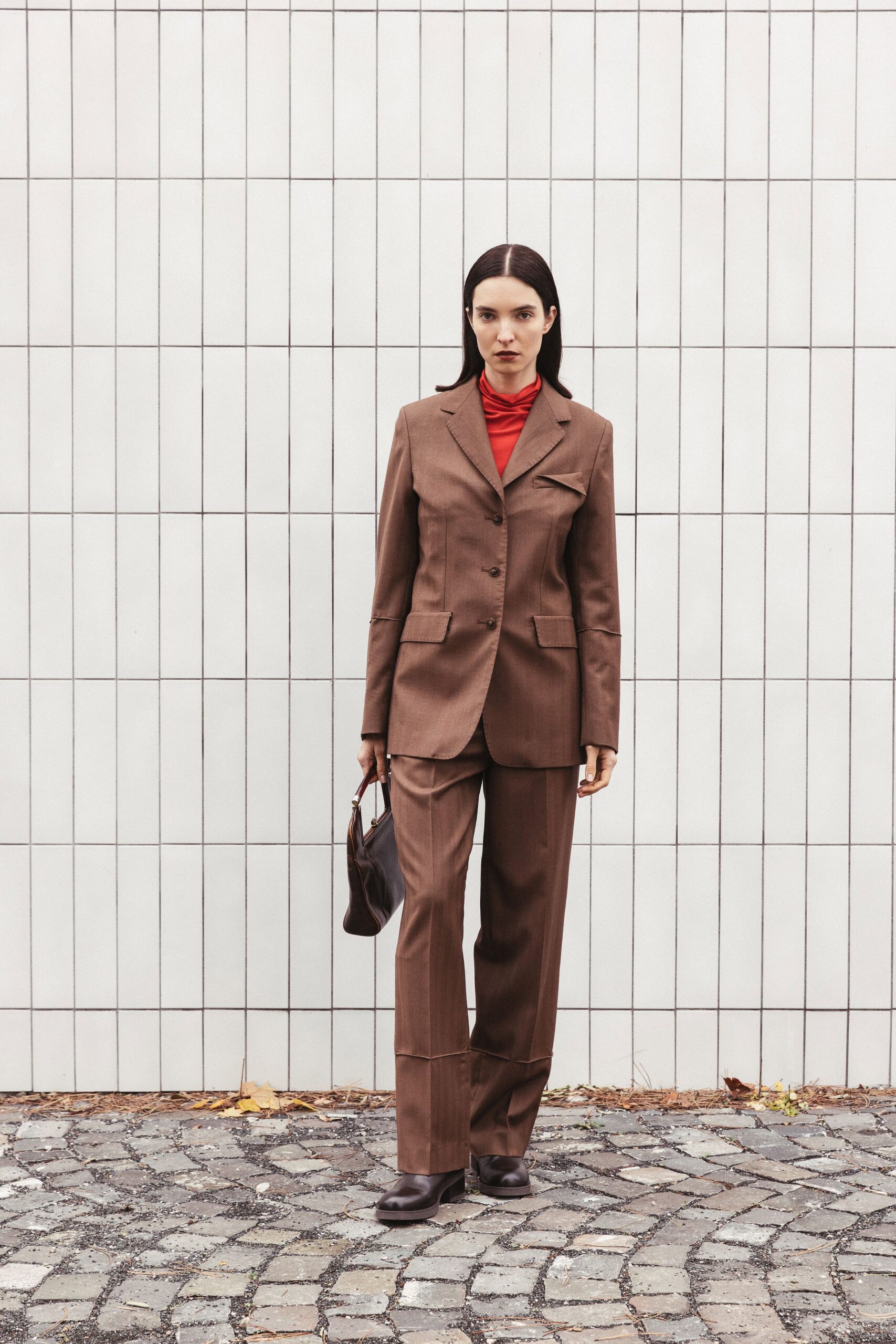 brown tailored suit with red top
