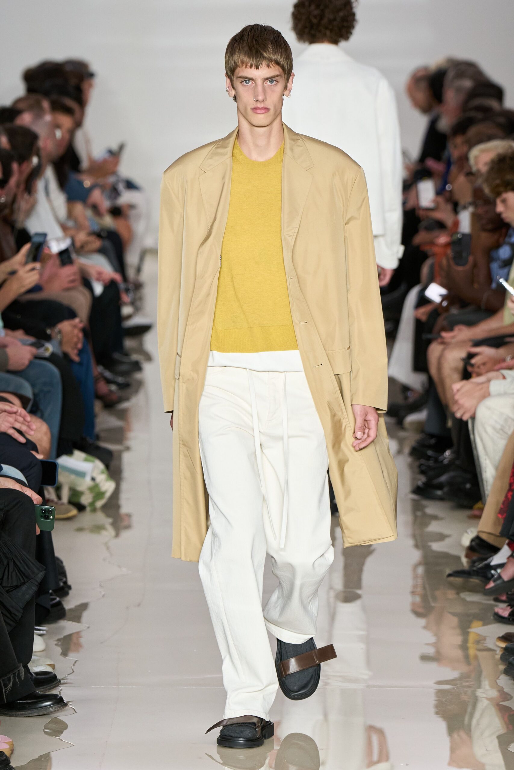 beige coat yellow top white pants