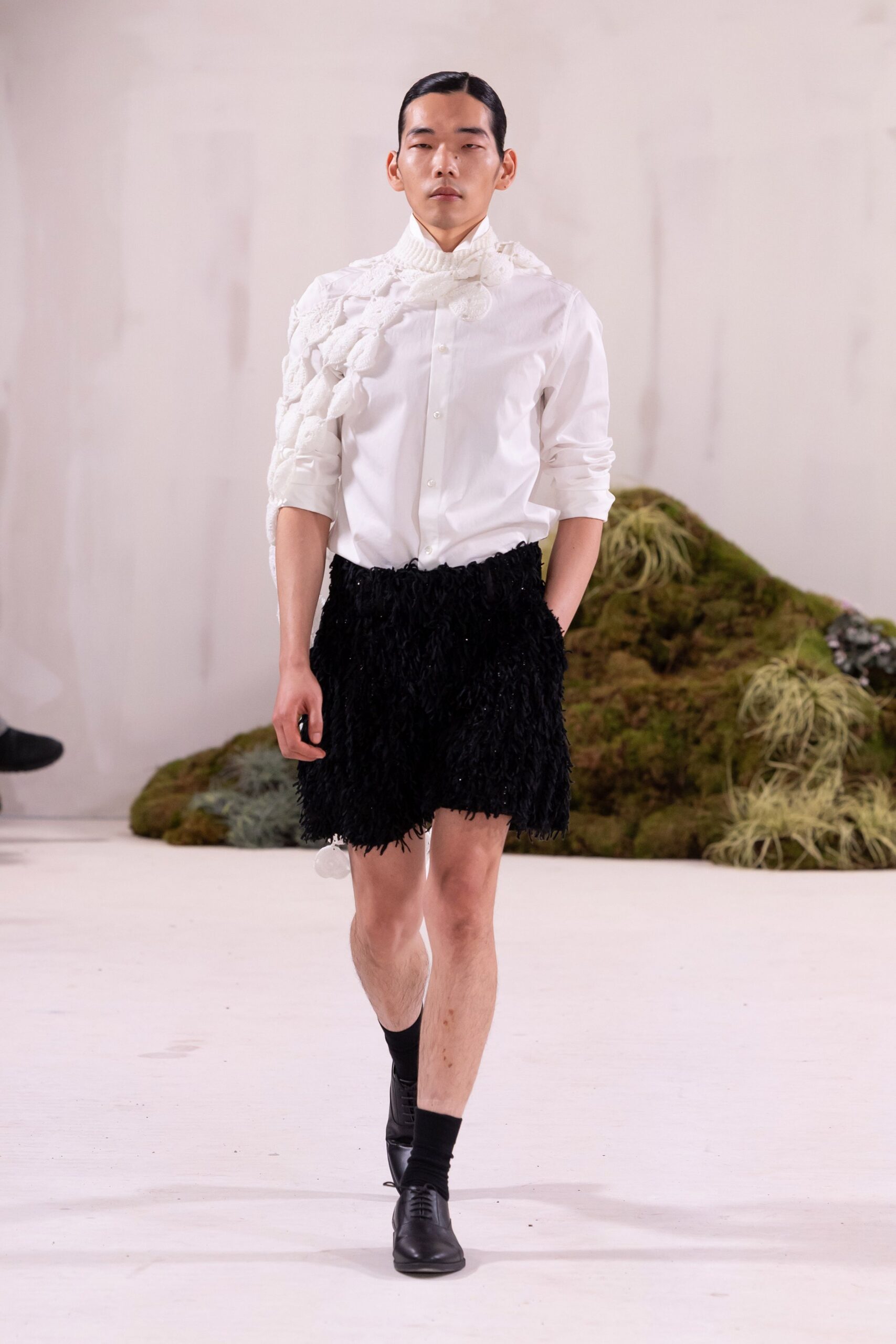 white shirt black fringed shorts