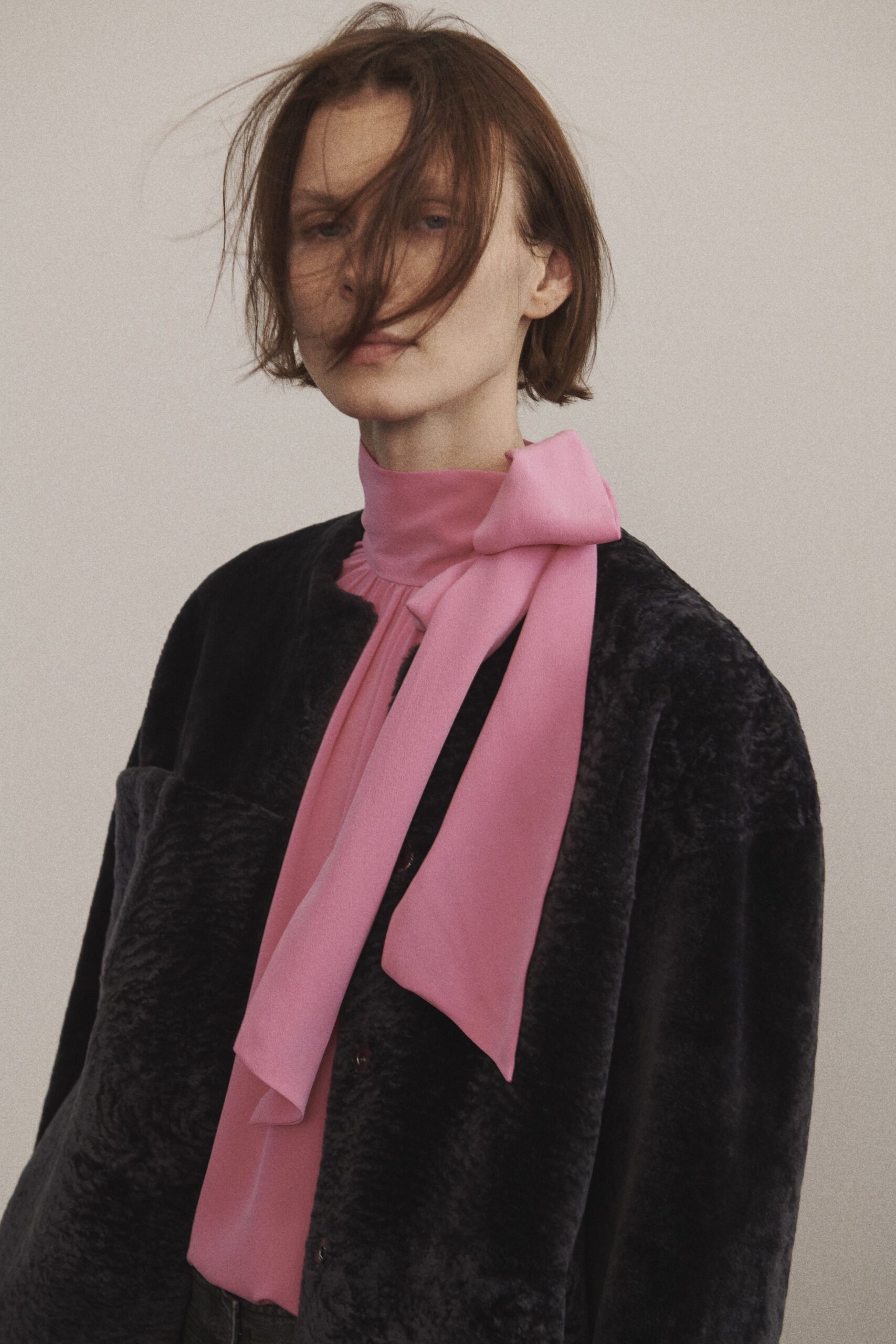 black fur jacket and pink blouse