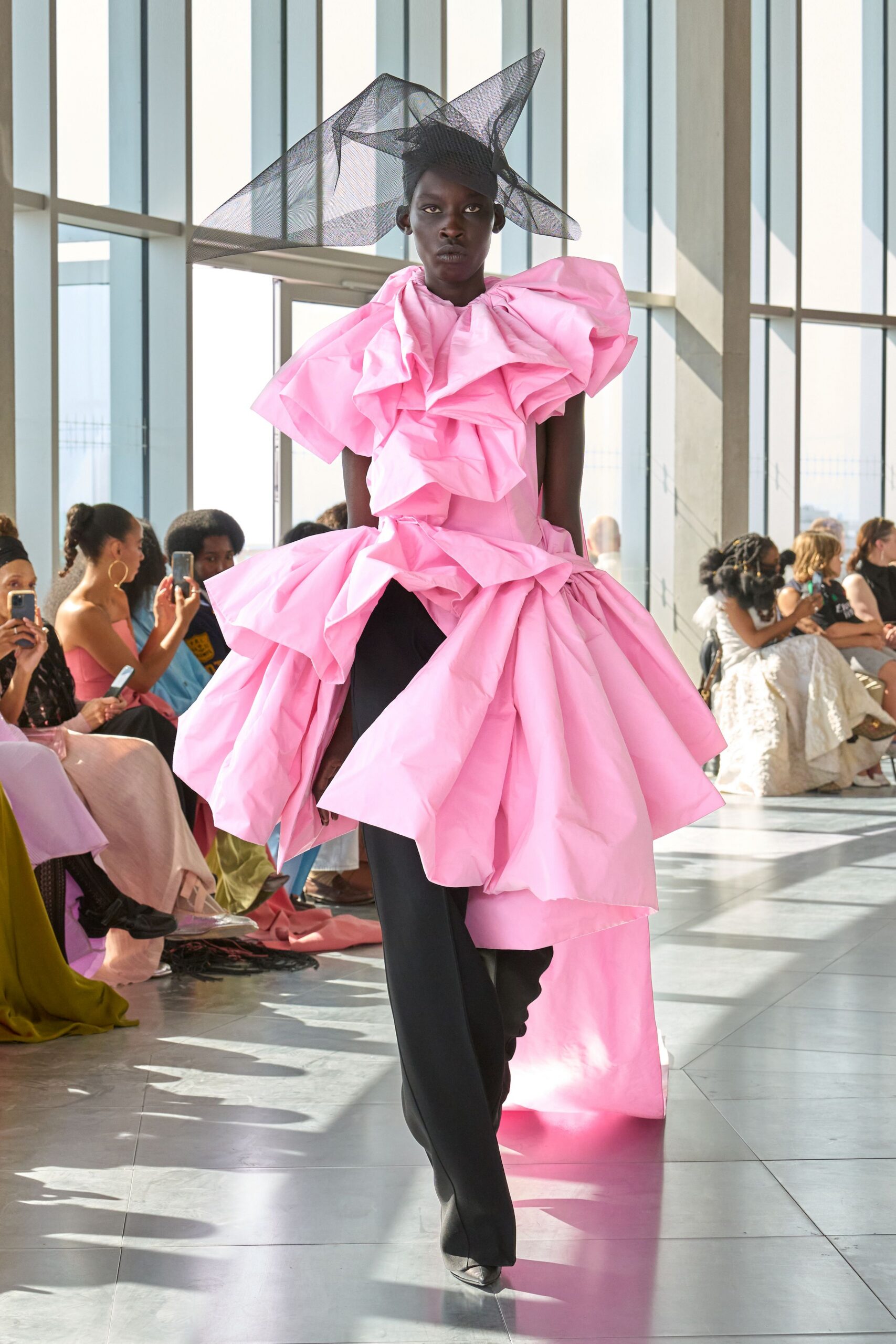 pink ruffled midi dress with black pants