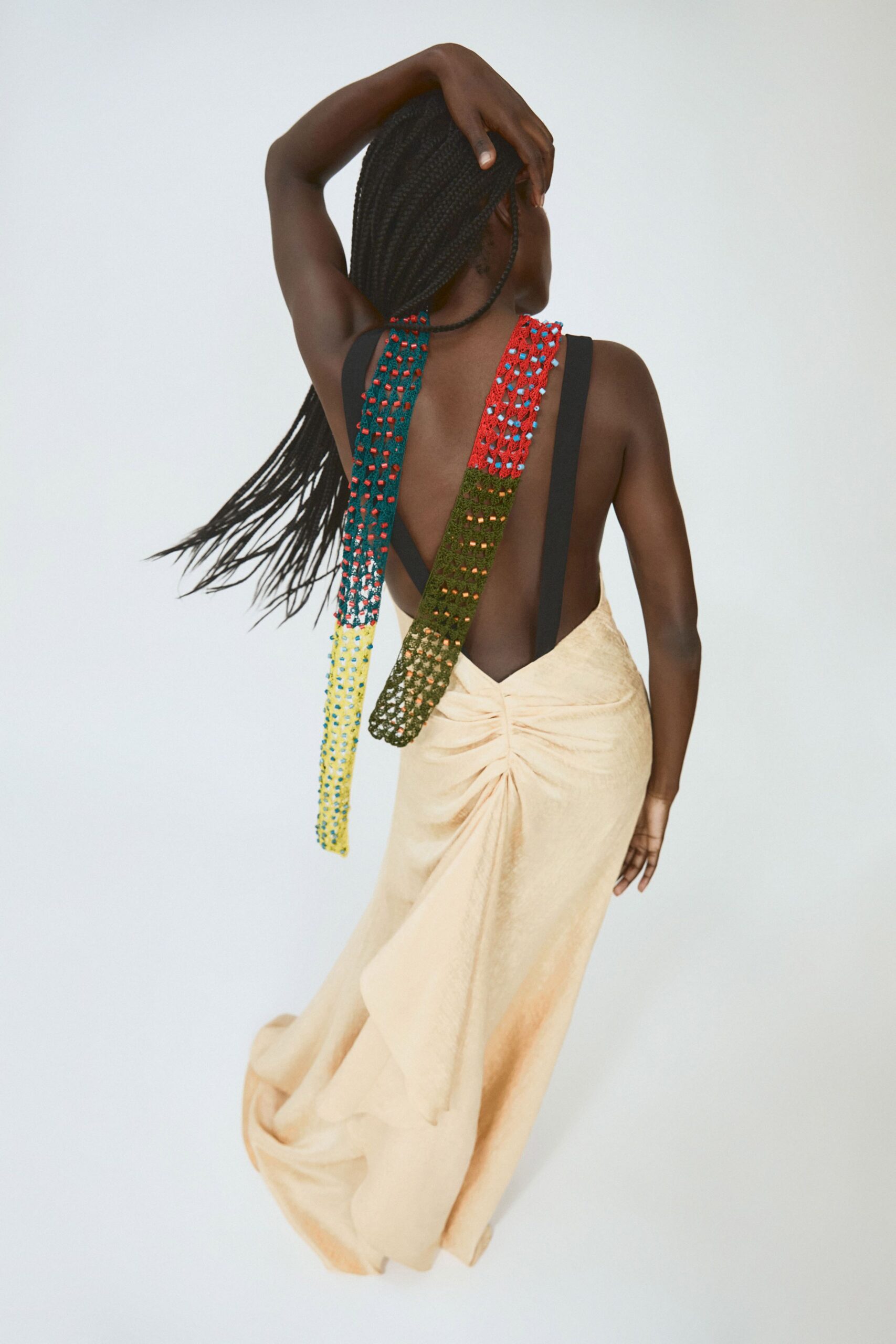 beige silk draped gown with multi-colored details