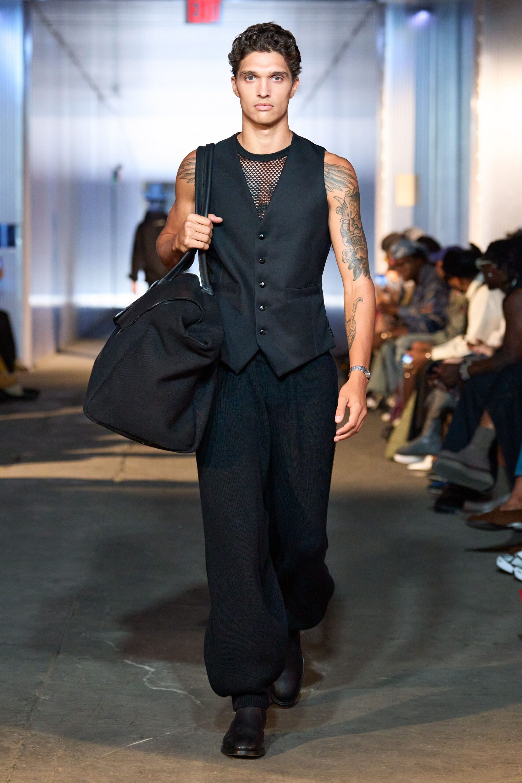 black fitted vest with relaxed pants