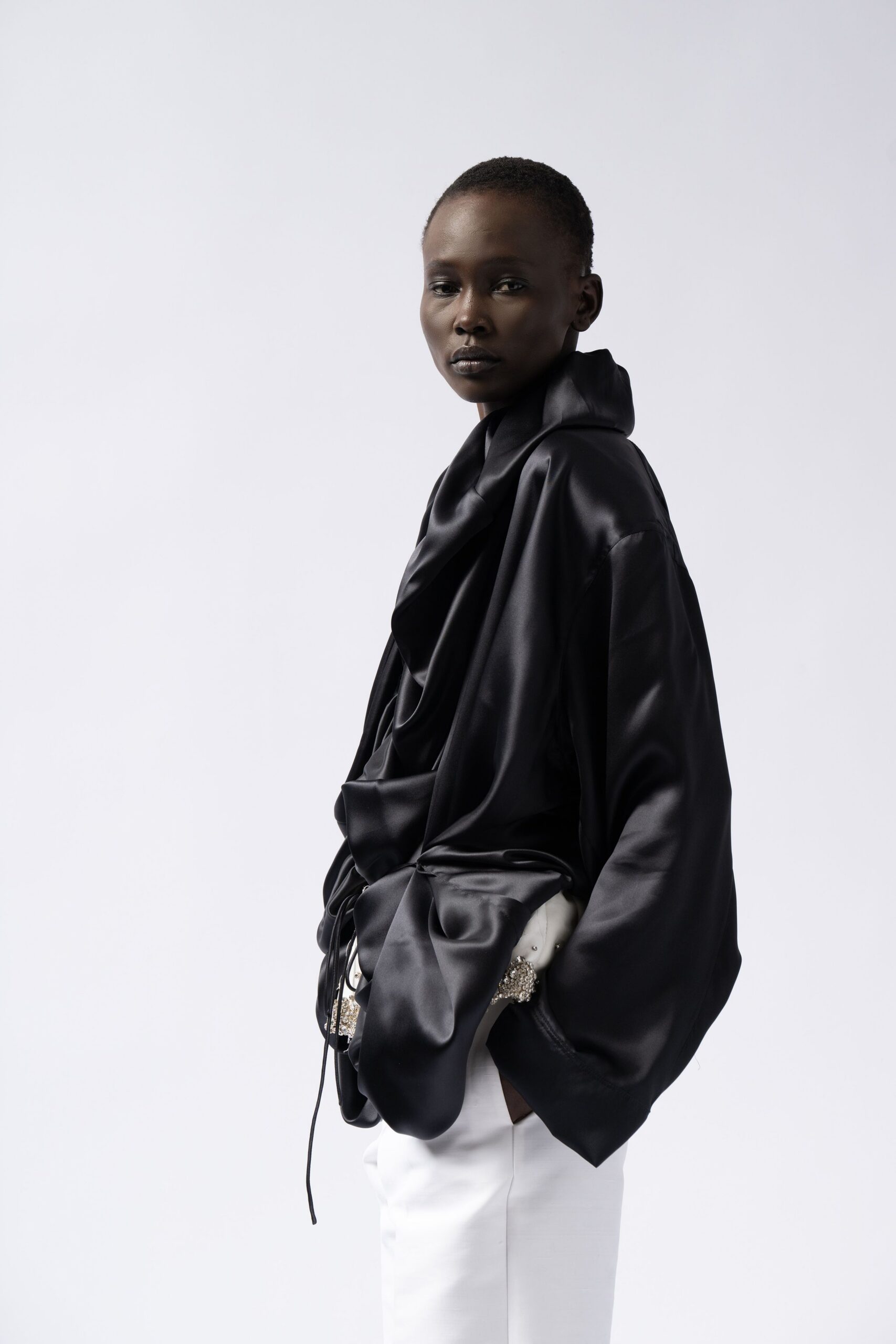 black silk relaxed top with white pants