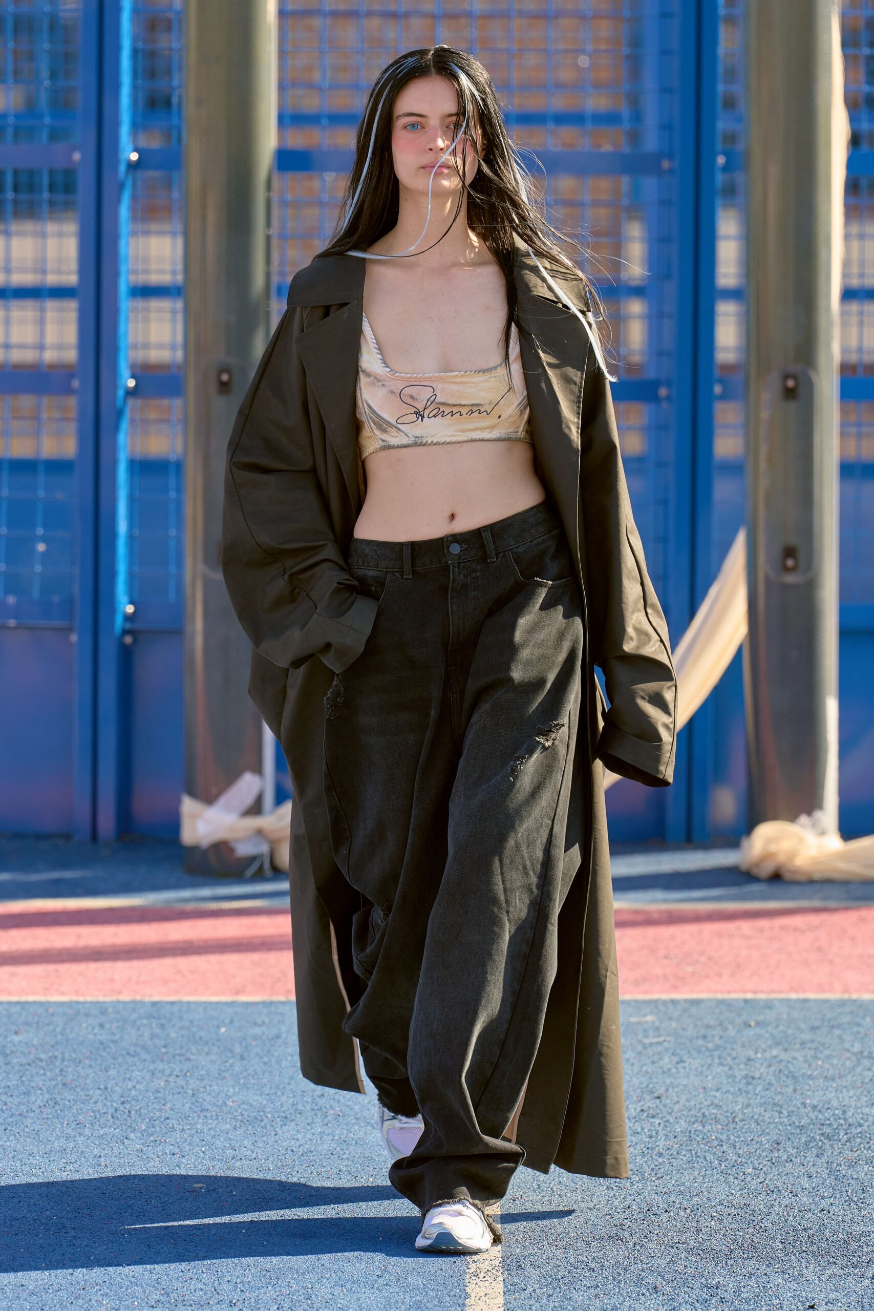 green coat beige crop-top black pants white sneakers