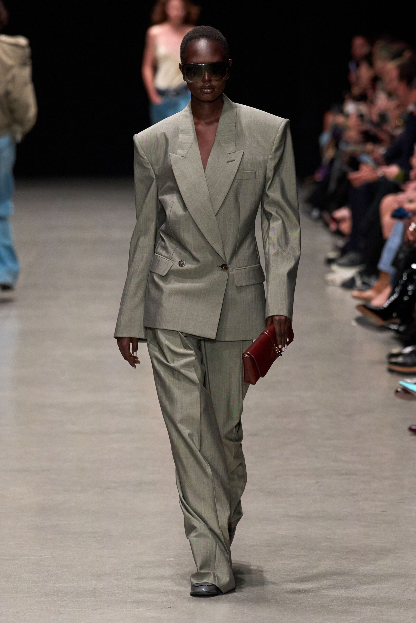 gray tailored suit with red bag