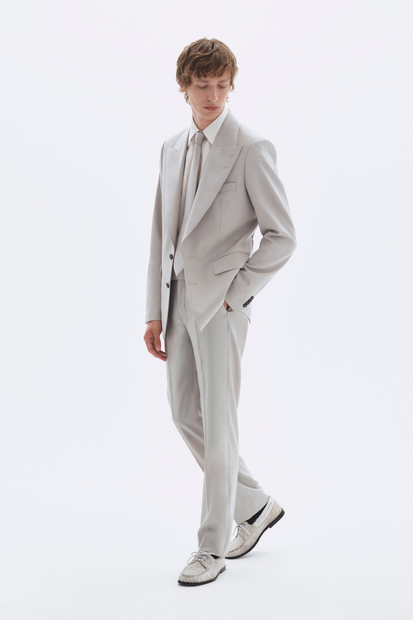 white tailored suit with gray shoes