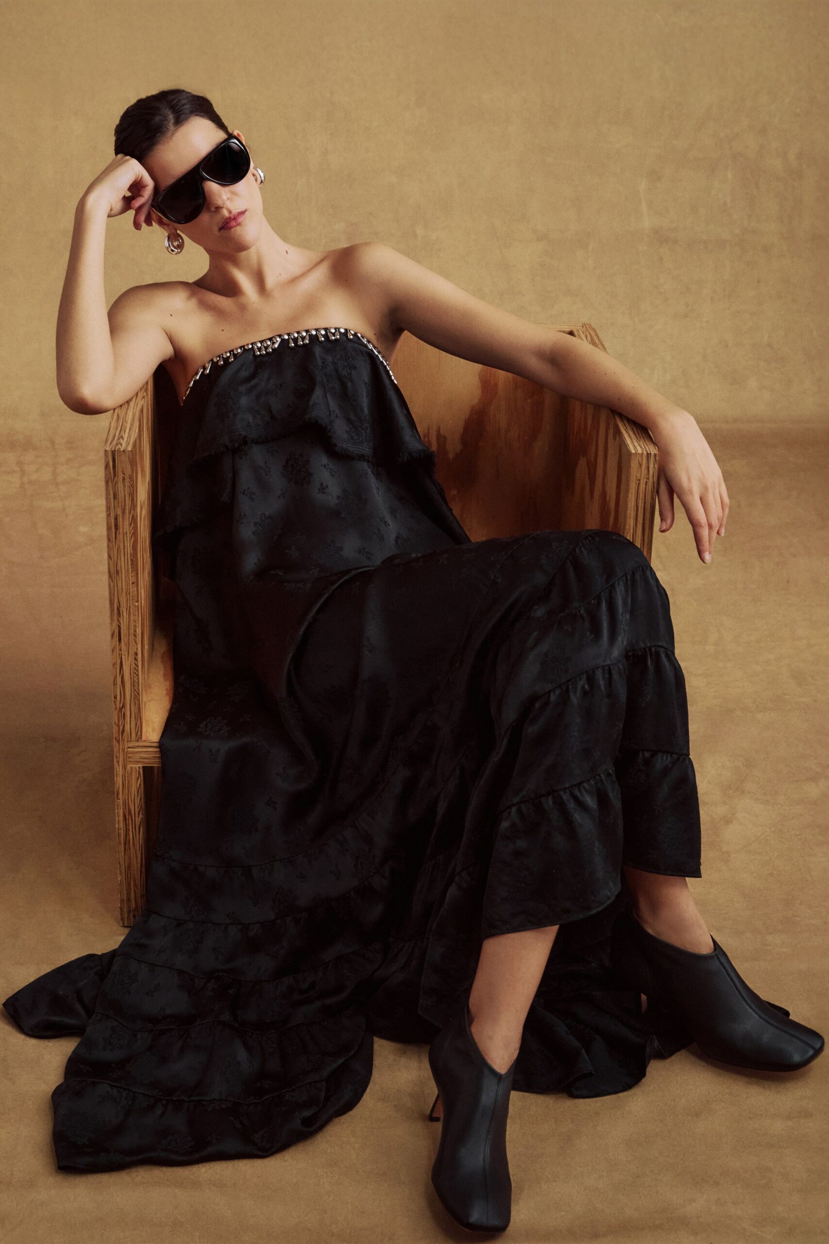 black silk strapless fitted ruffled tiered flowing gown