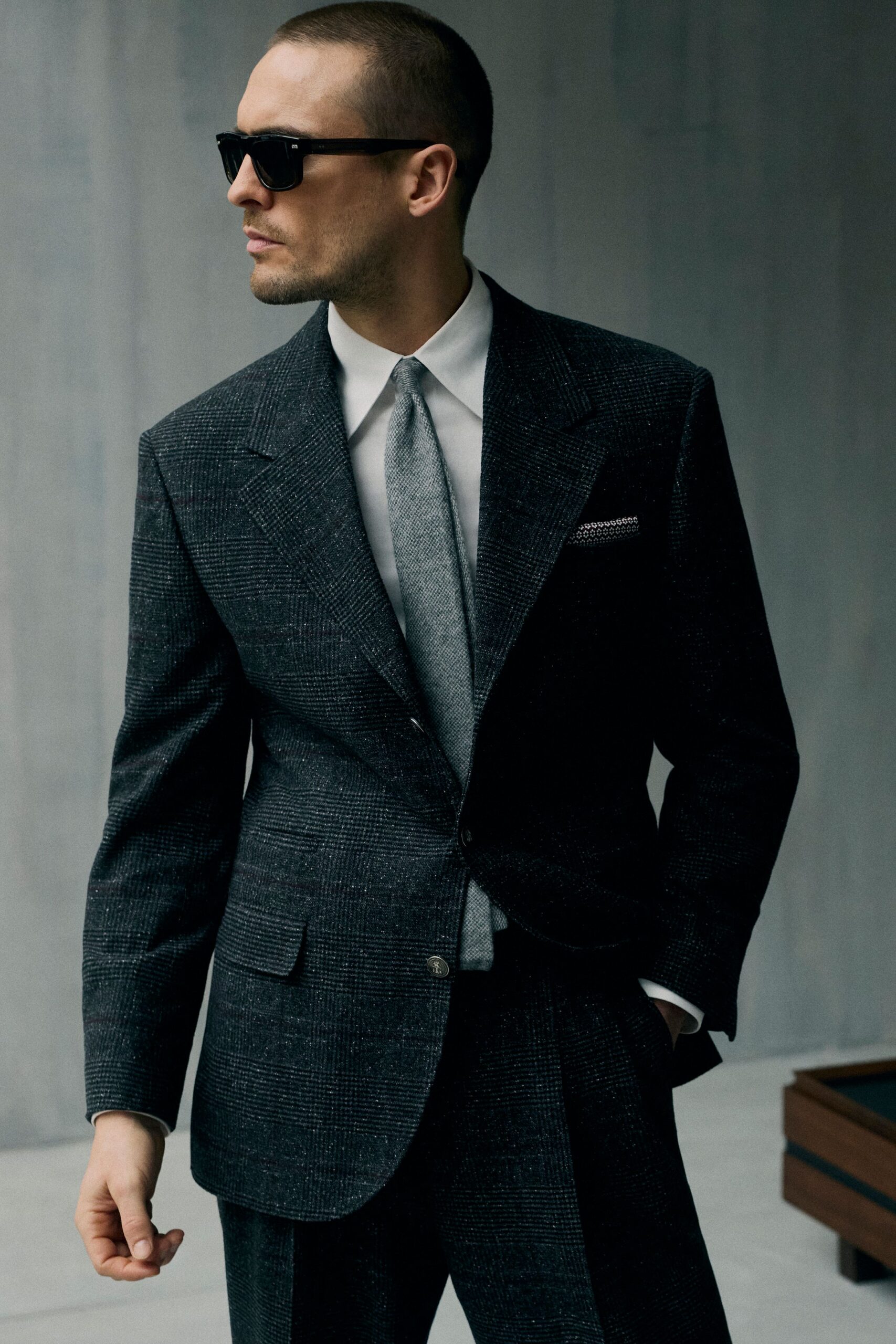 gray tailored suit with sunglasses