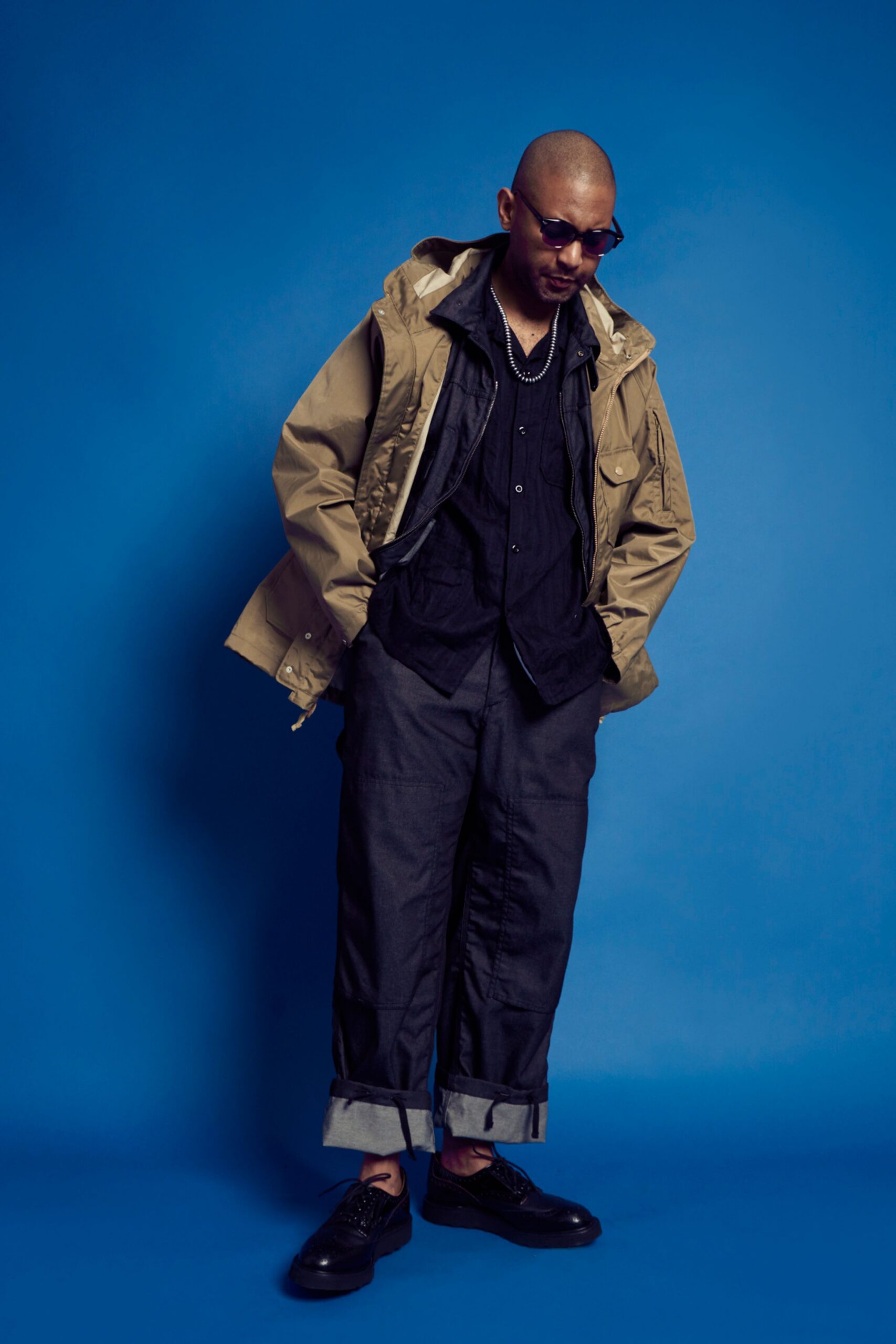 beige jacket black shirt gray pants