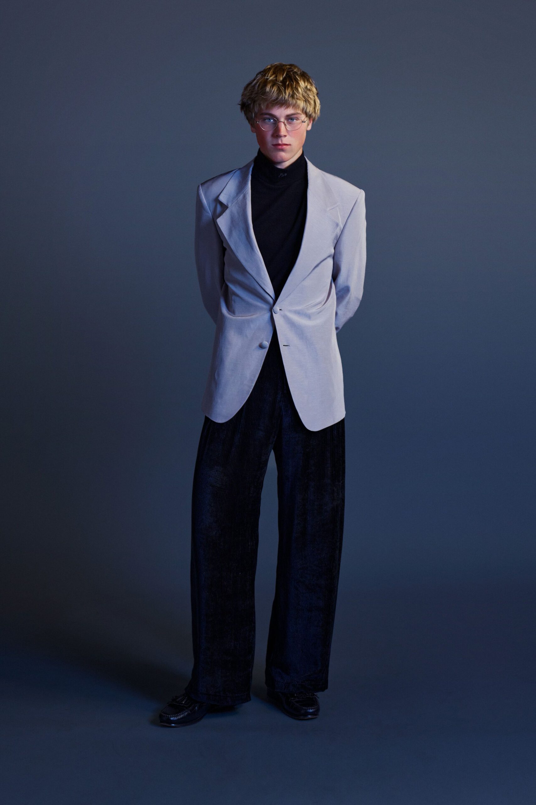 gray tailored blazer with black turtleneck