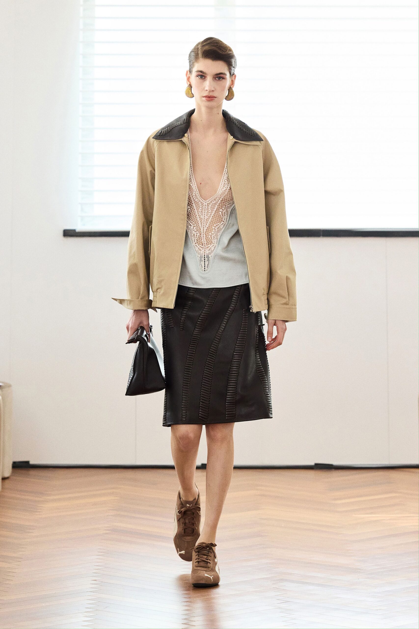 beige jacket white top black skirt