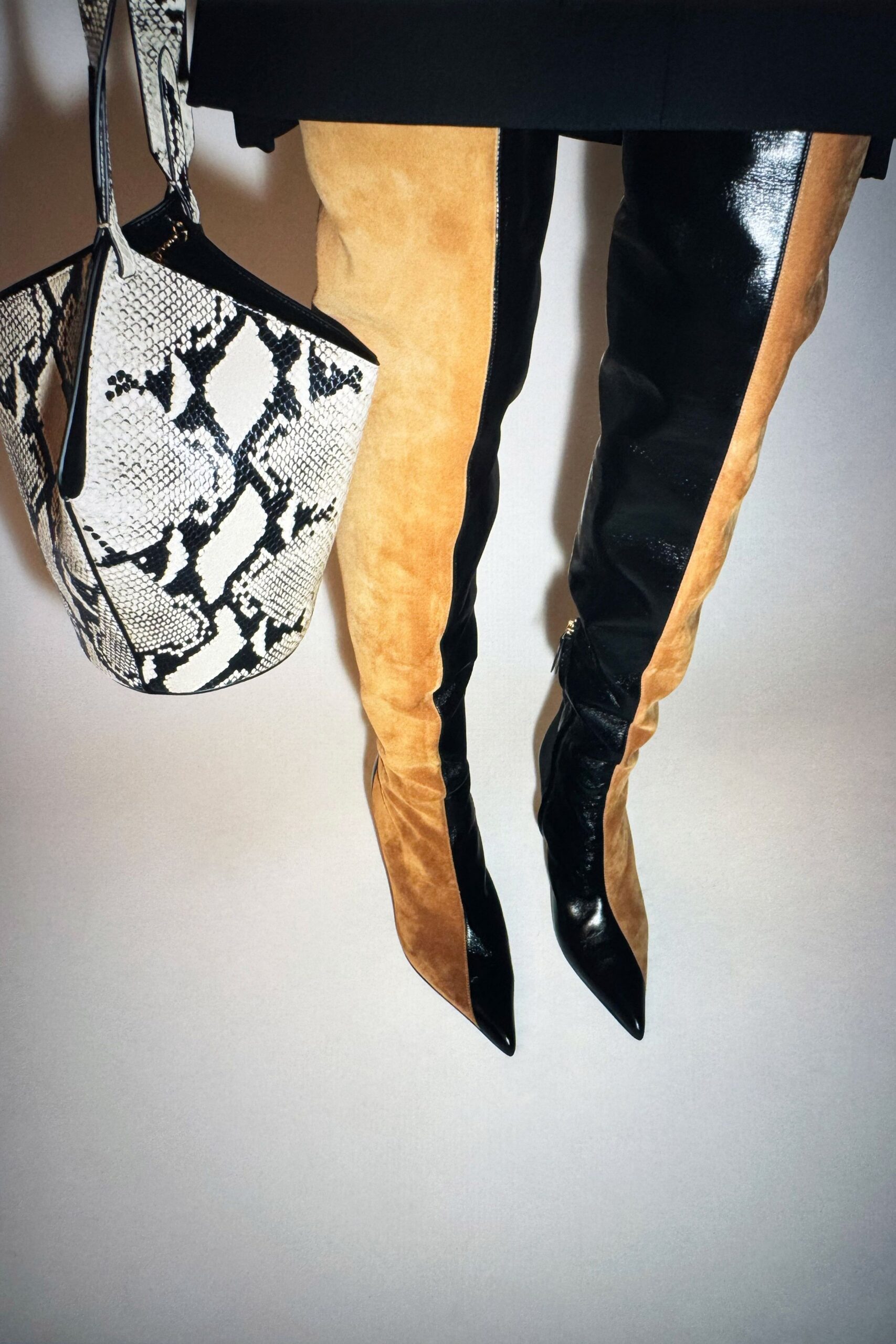 color-blocked leather boots and animal-print bag
