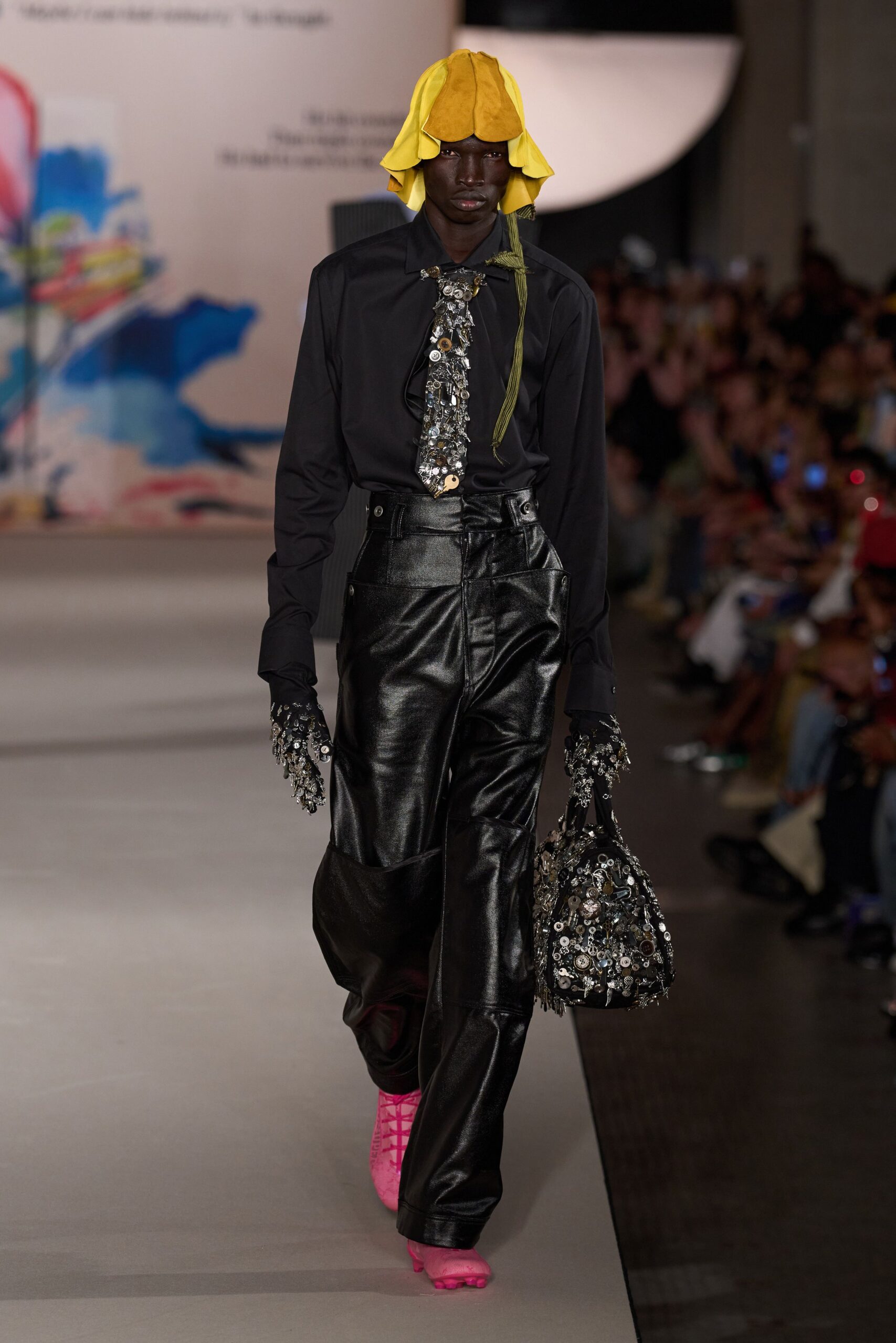 black shirt leather pants yellow hat