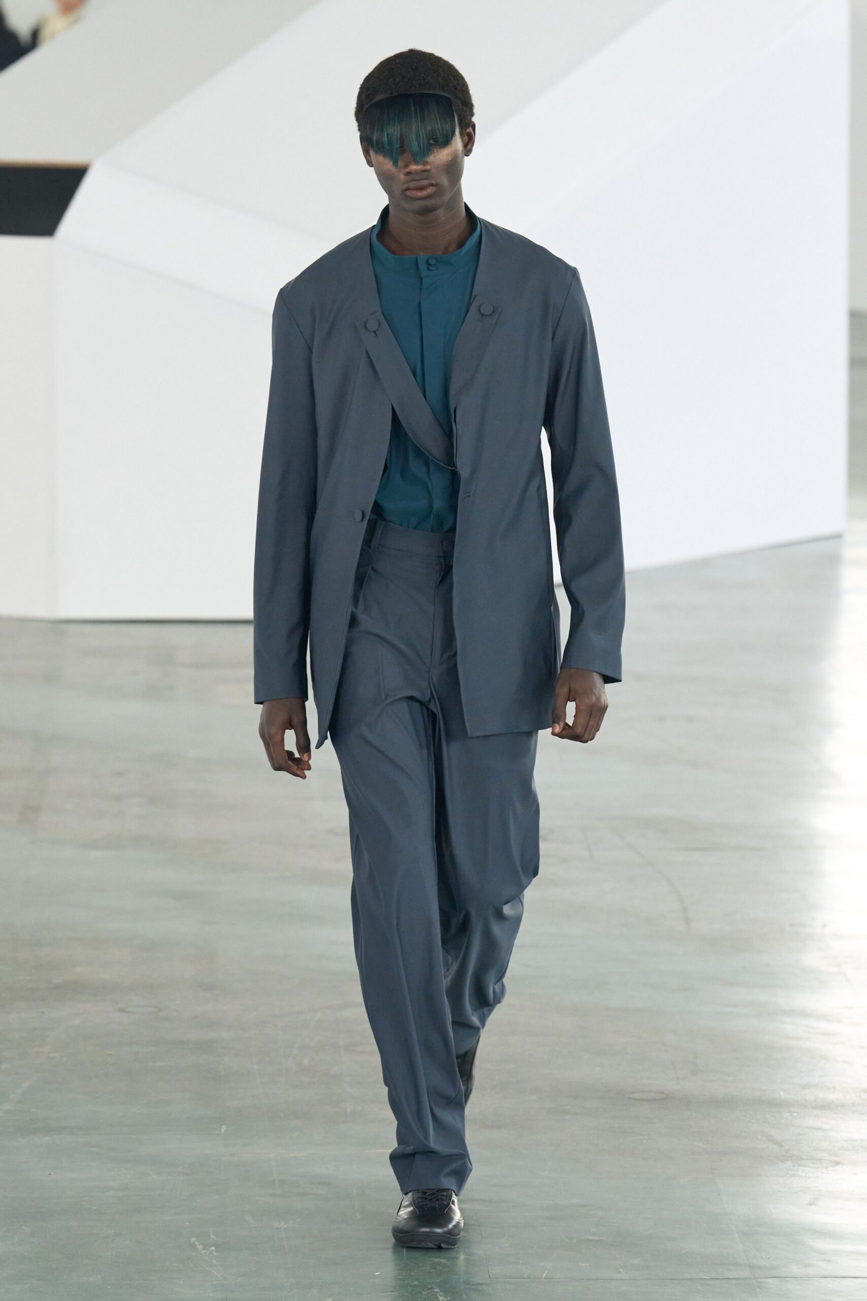 blue tailored suit with teal shirt