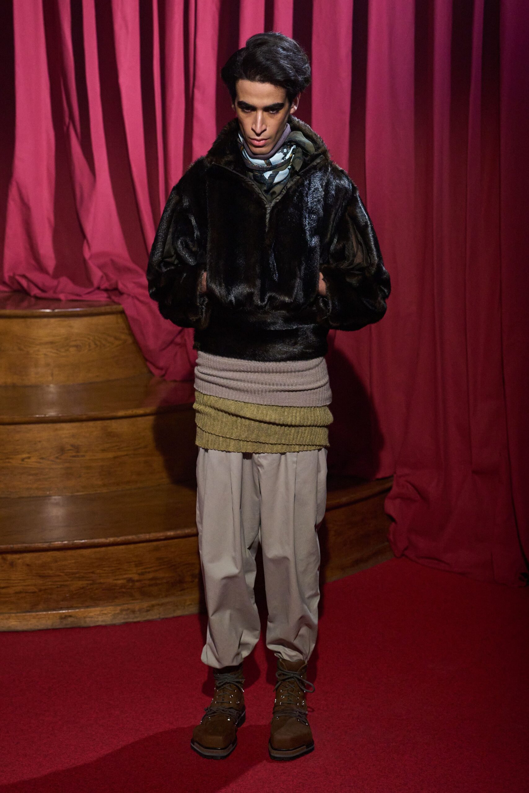 black faux-fur jacket with beige pants