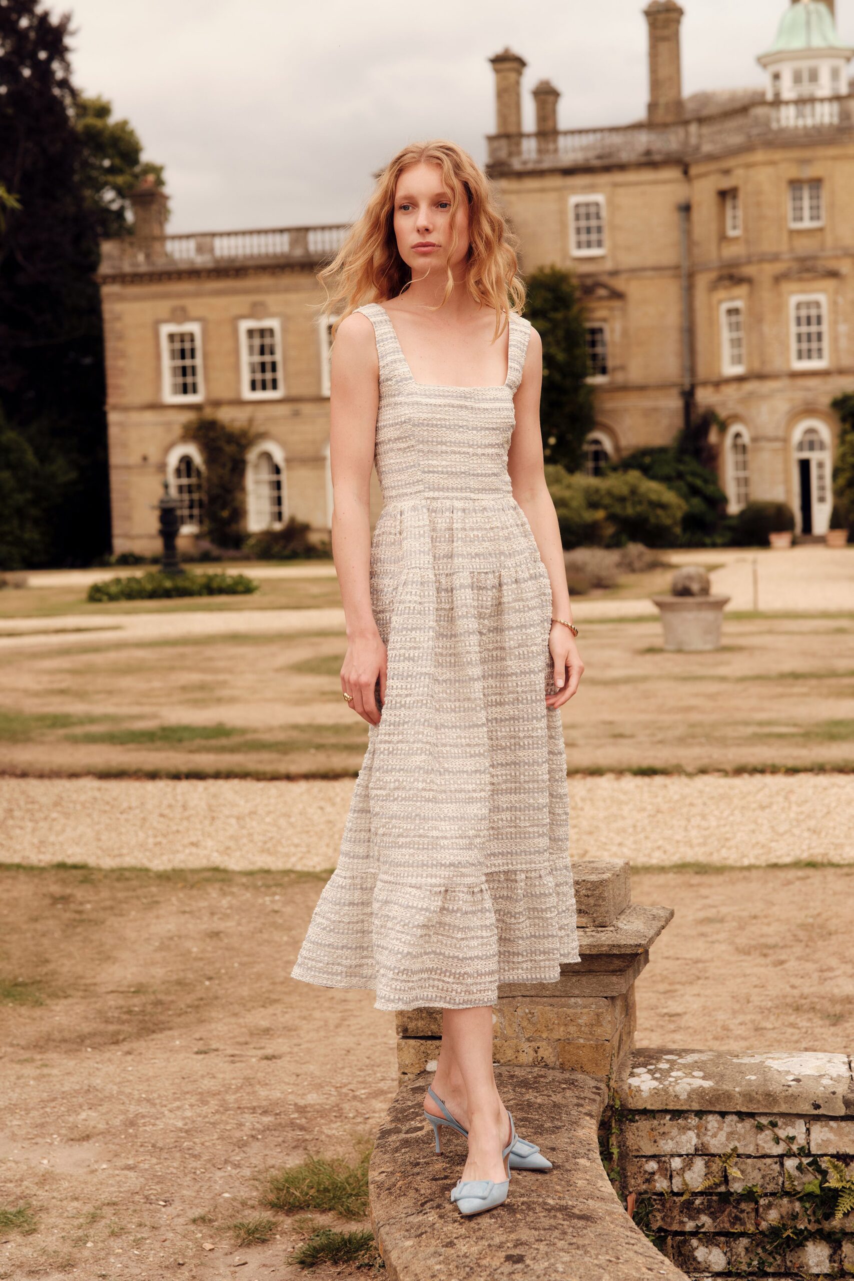 beige tiered midi dress with blue shoes
