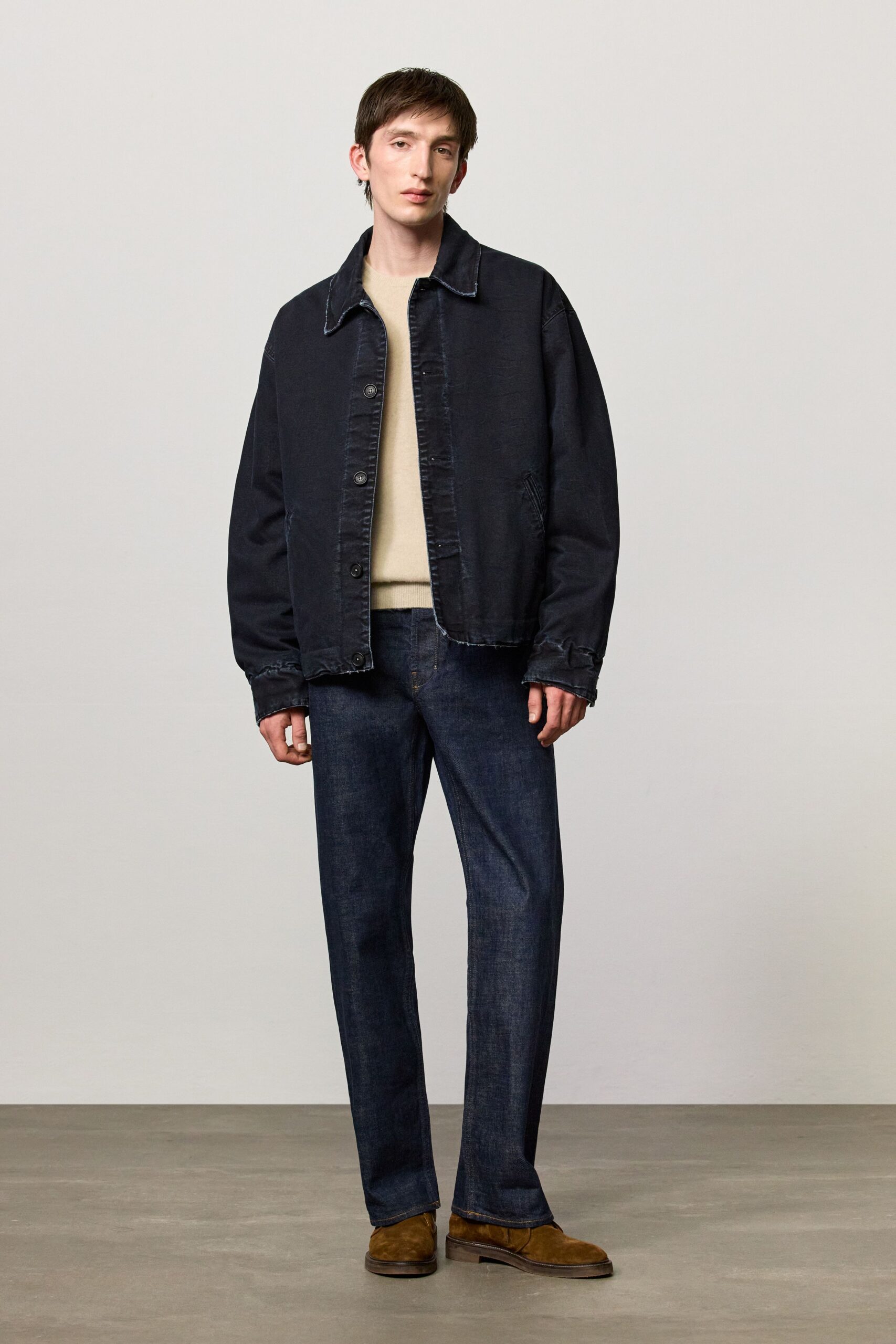 black denim jacket beige sweater blue pants brown shoes