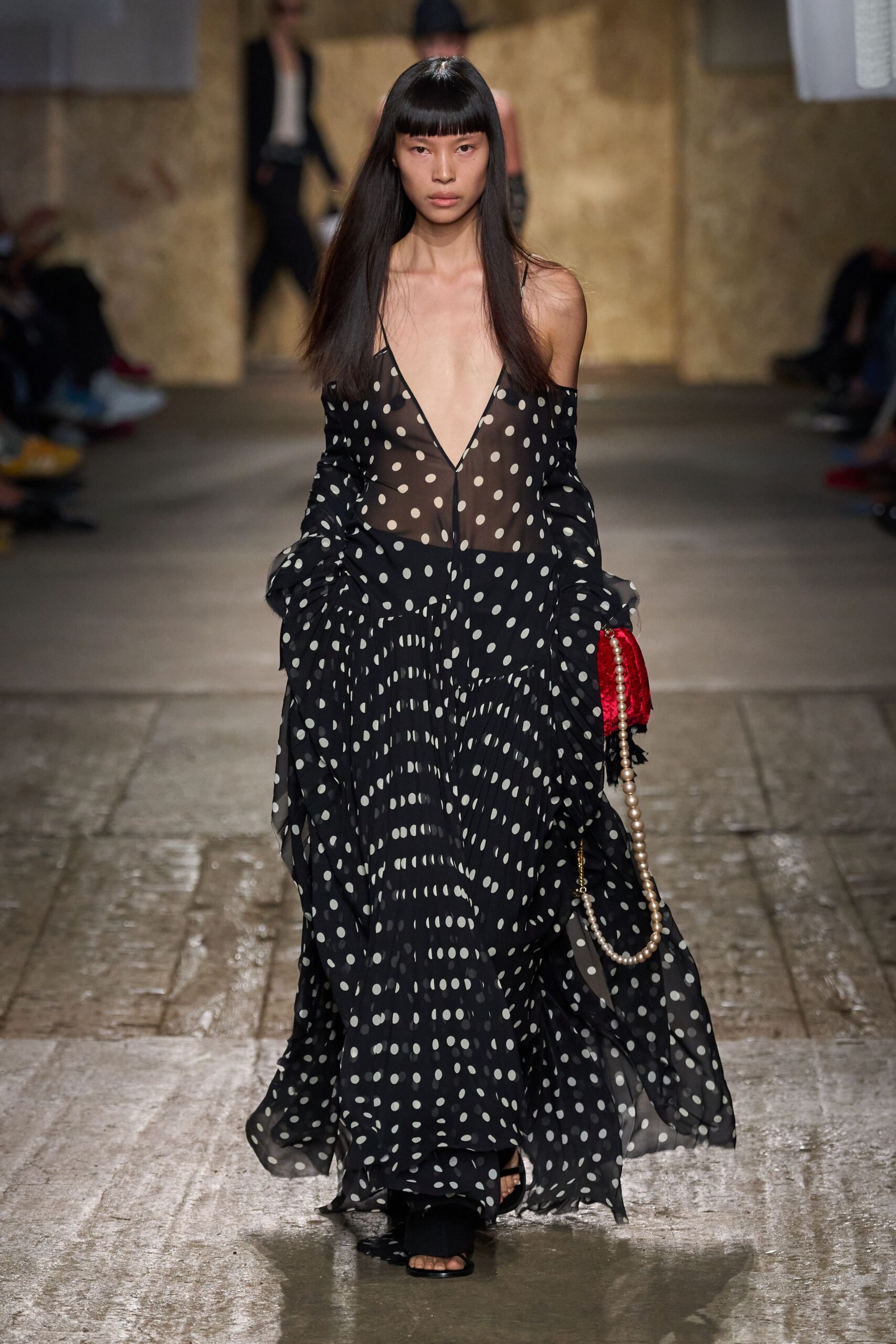 black and white polka-dot maxi dress with red bag