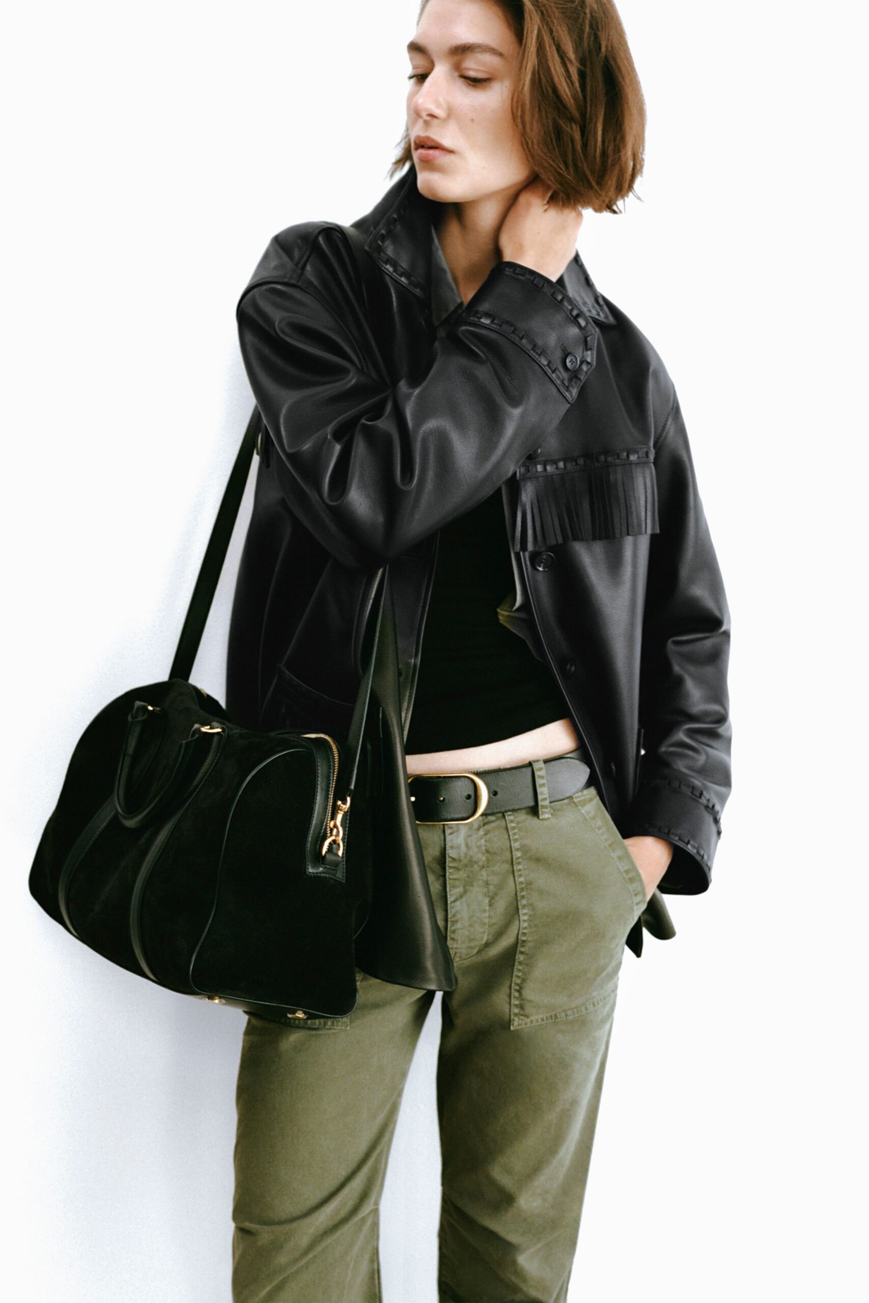 black leather jacket with green pants