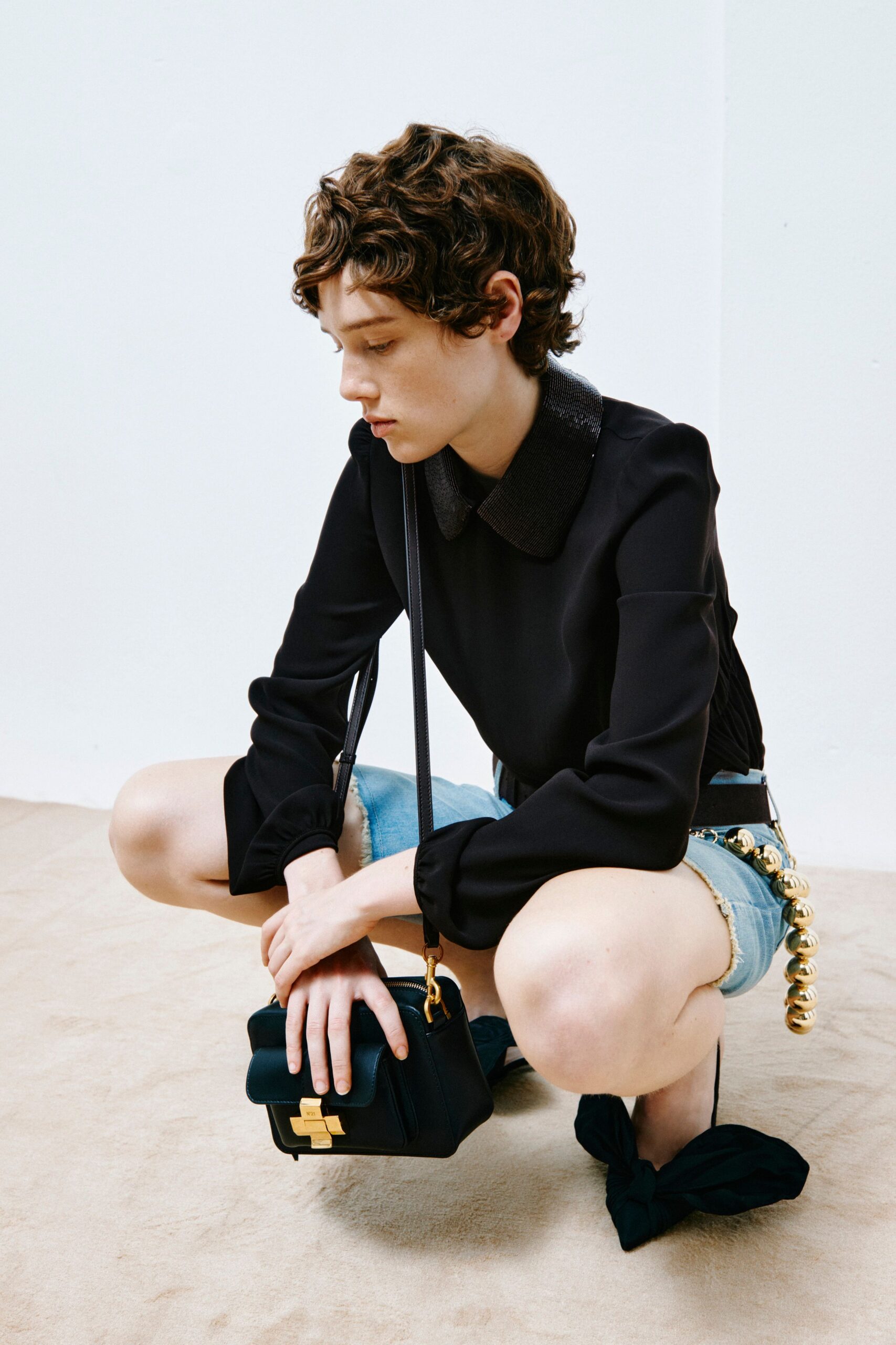 black silk top with denim shorts