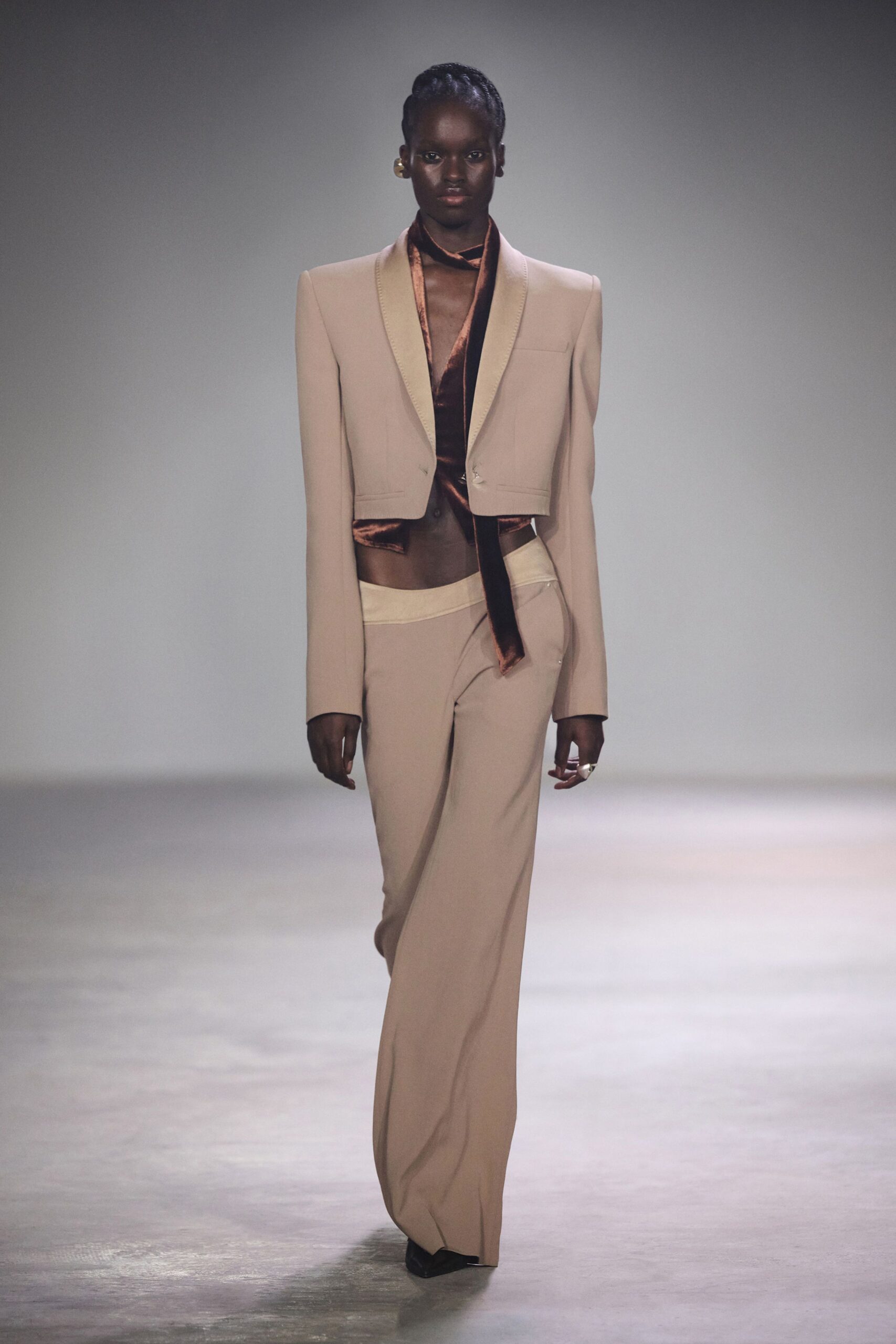 beige blazer with black top and tailored pants