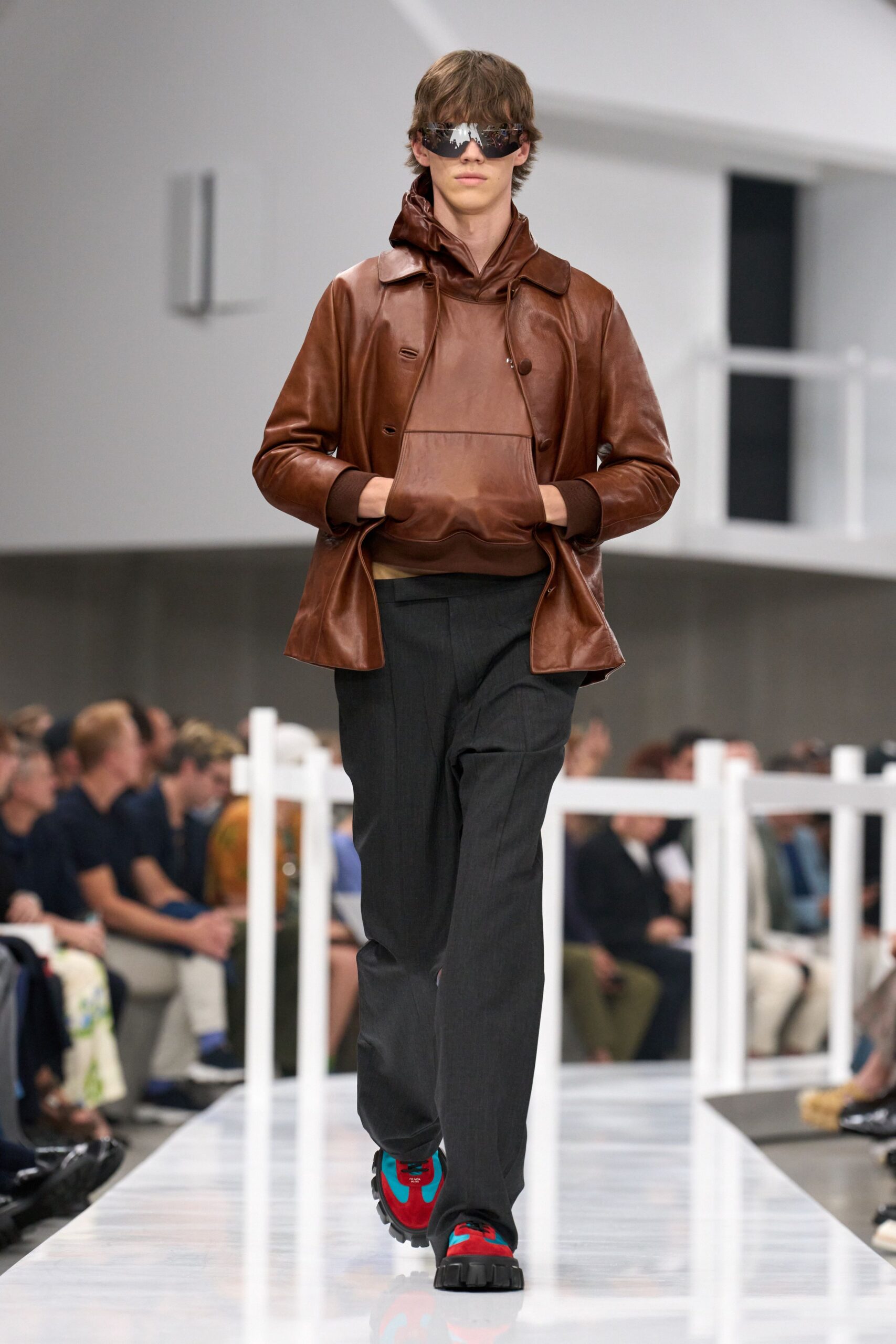 brown leather jacket with gray pants