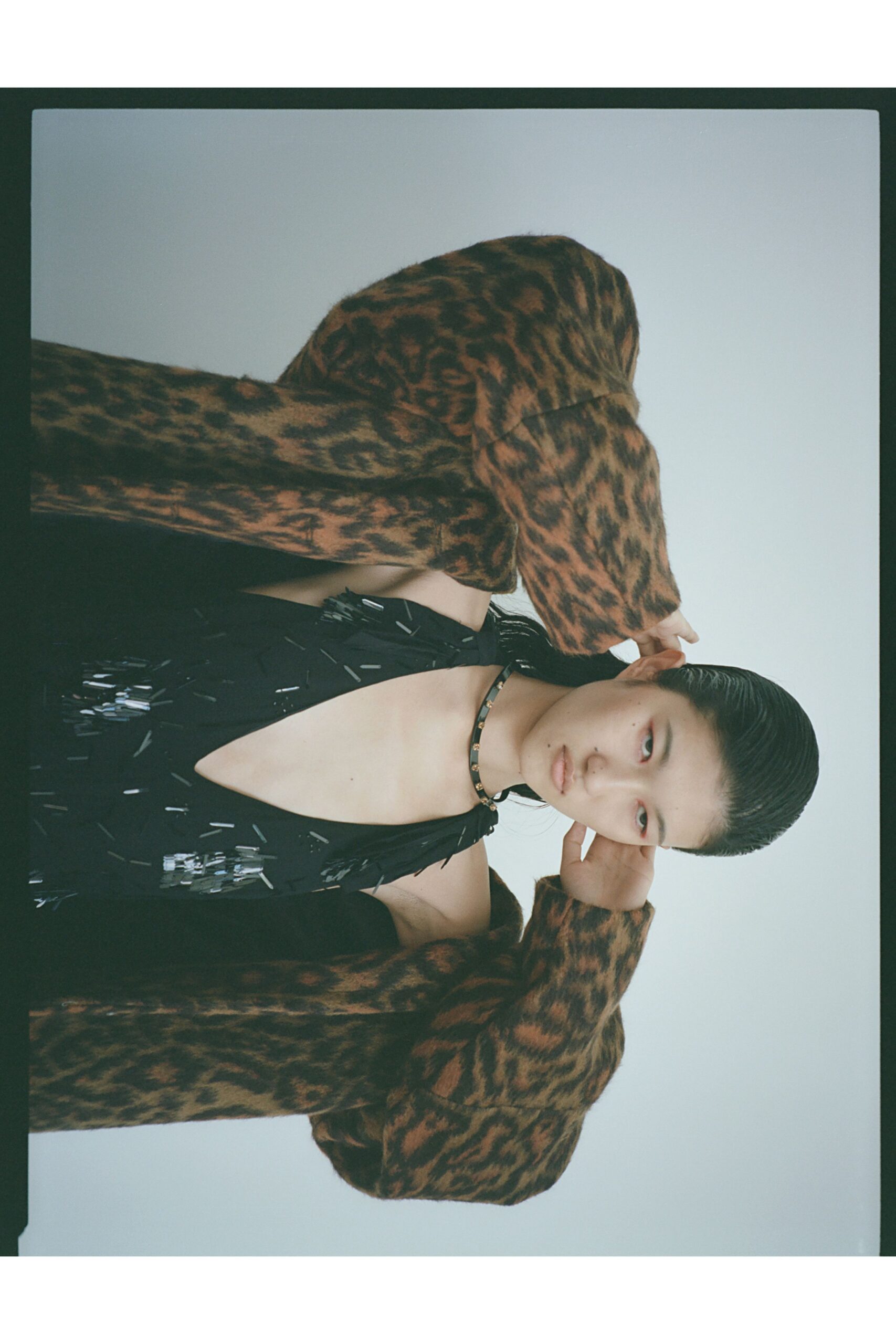 black silk sleeveless dress with animal-print coat