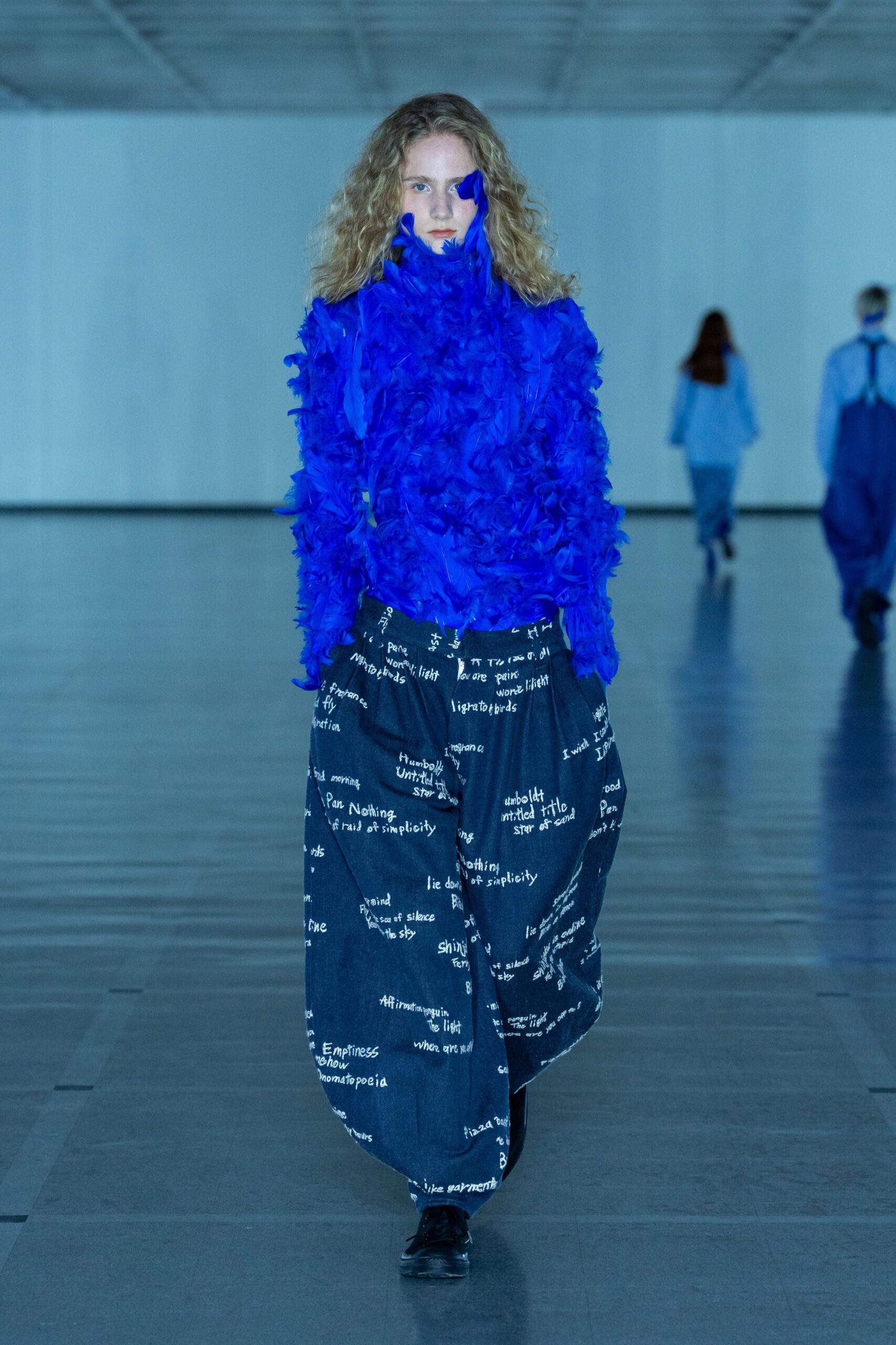 blue ruffled top with black pants