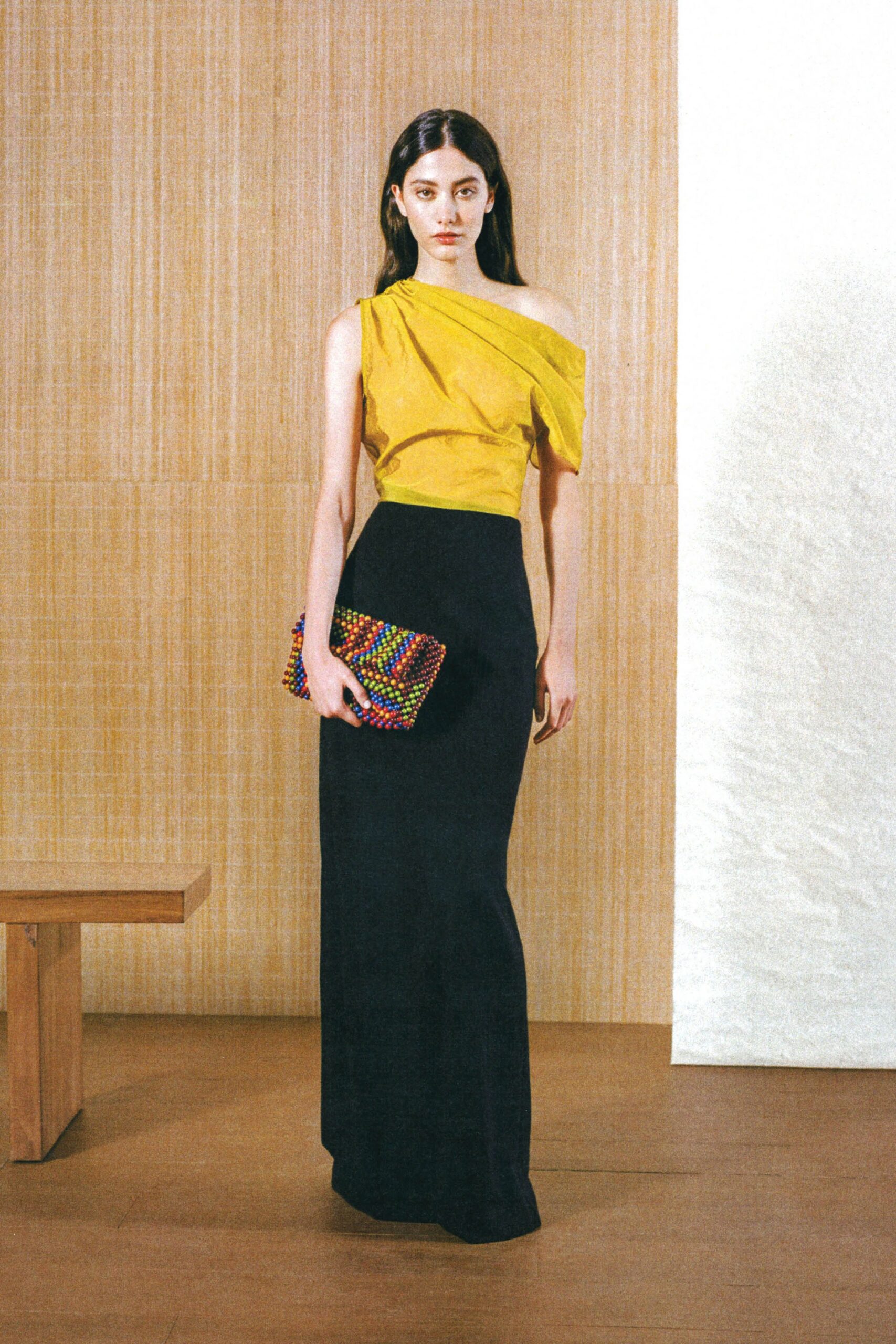 yellow silk off-shoulder top with black skirt
