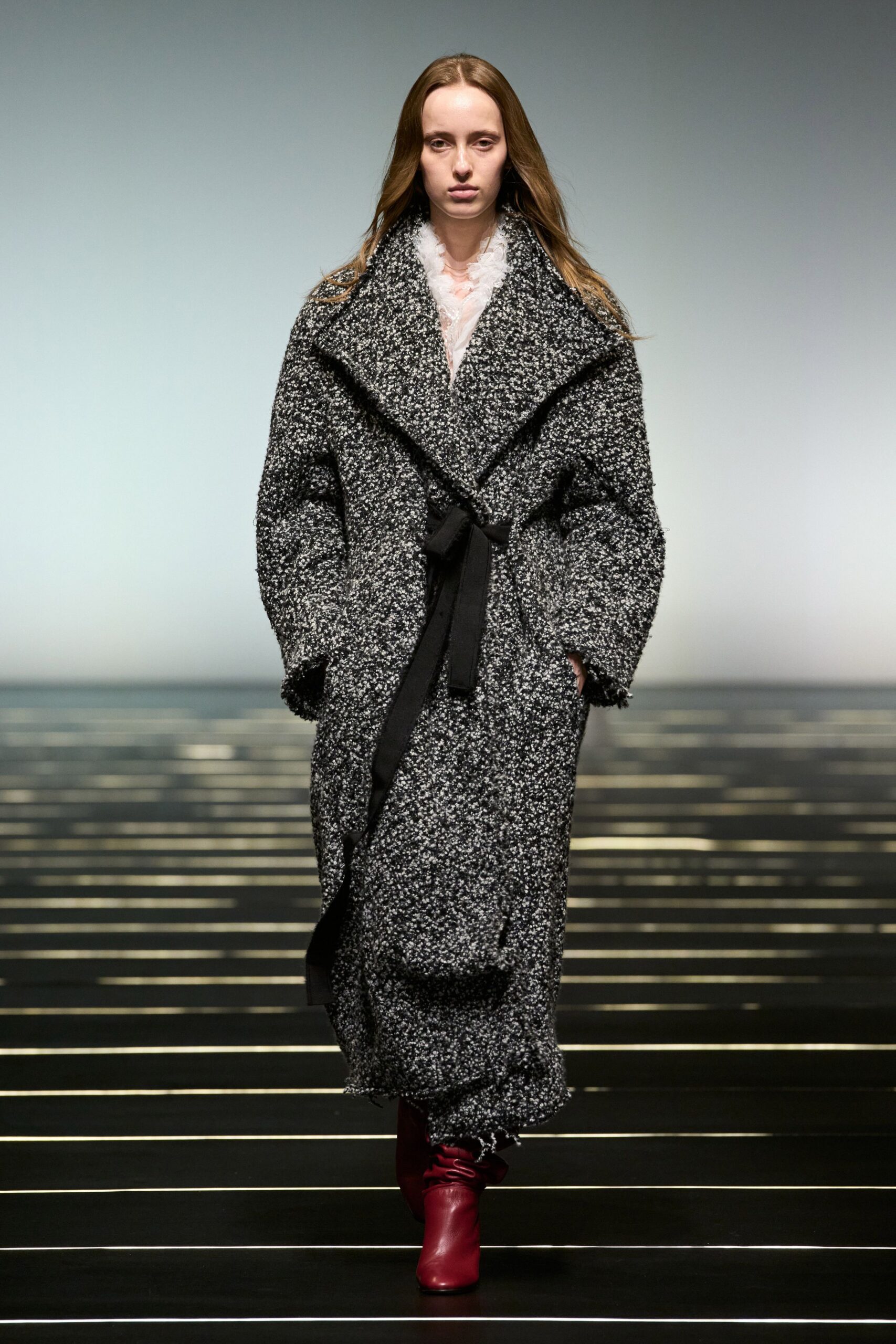 relaxed black and white wool coat with red boots