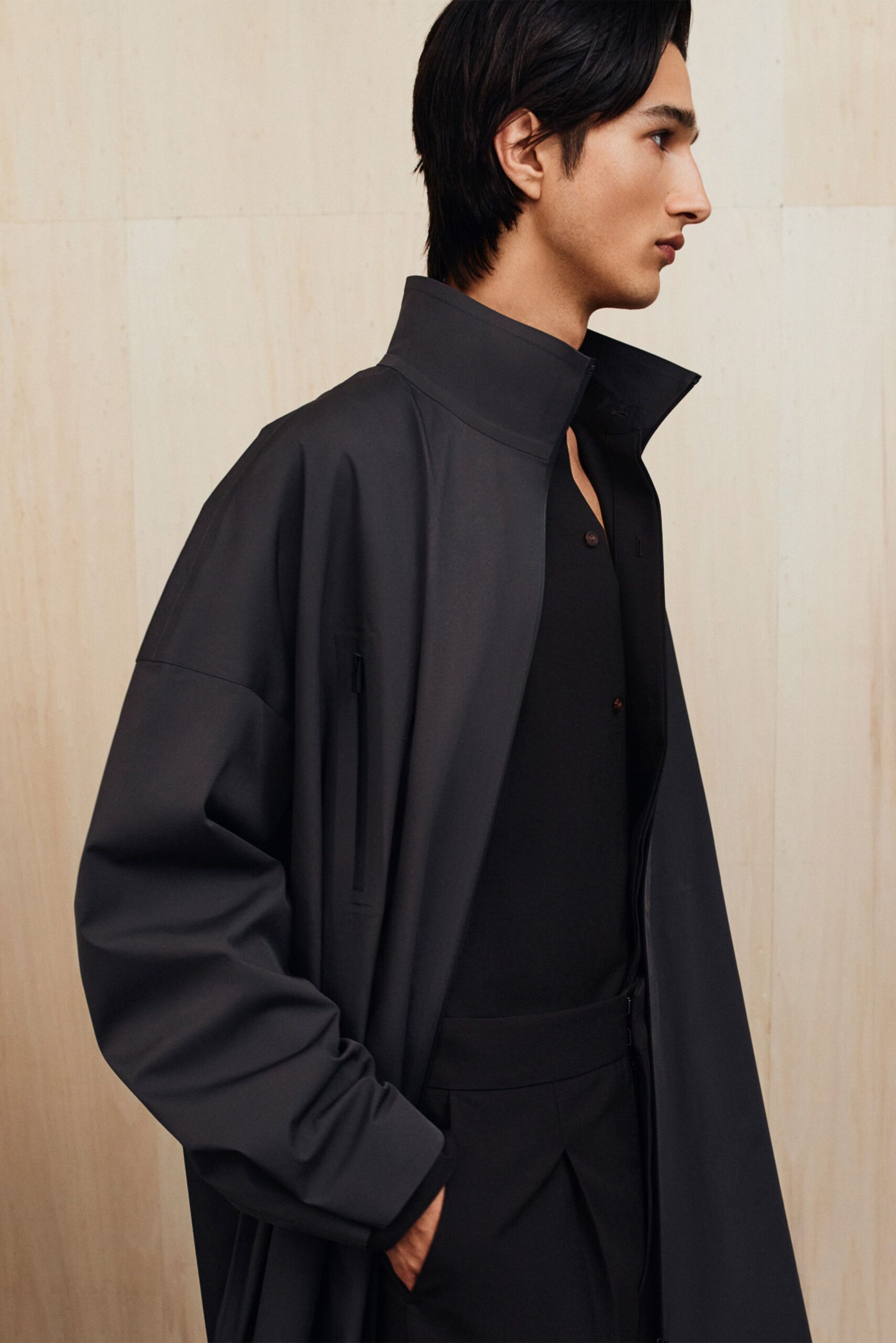 black oversized coat with fitted shirt and tailored pants