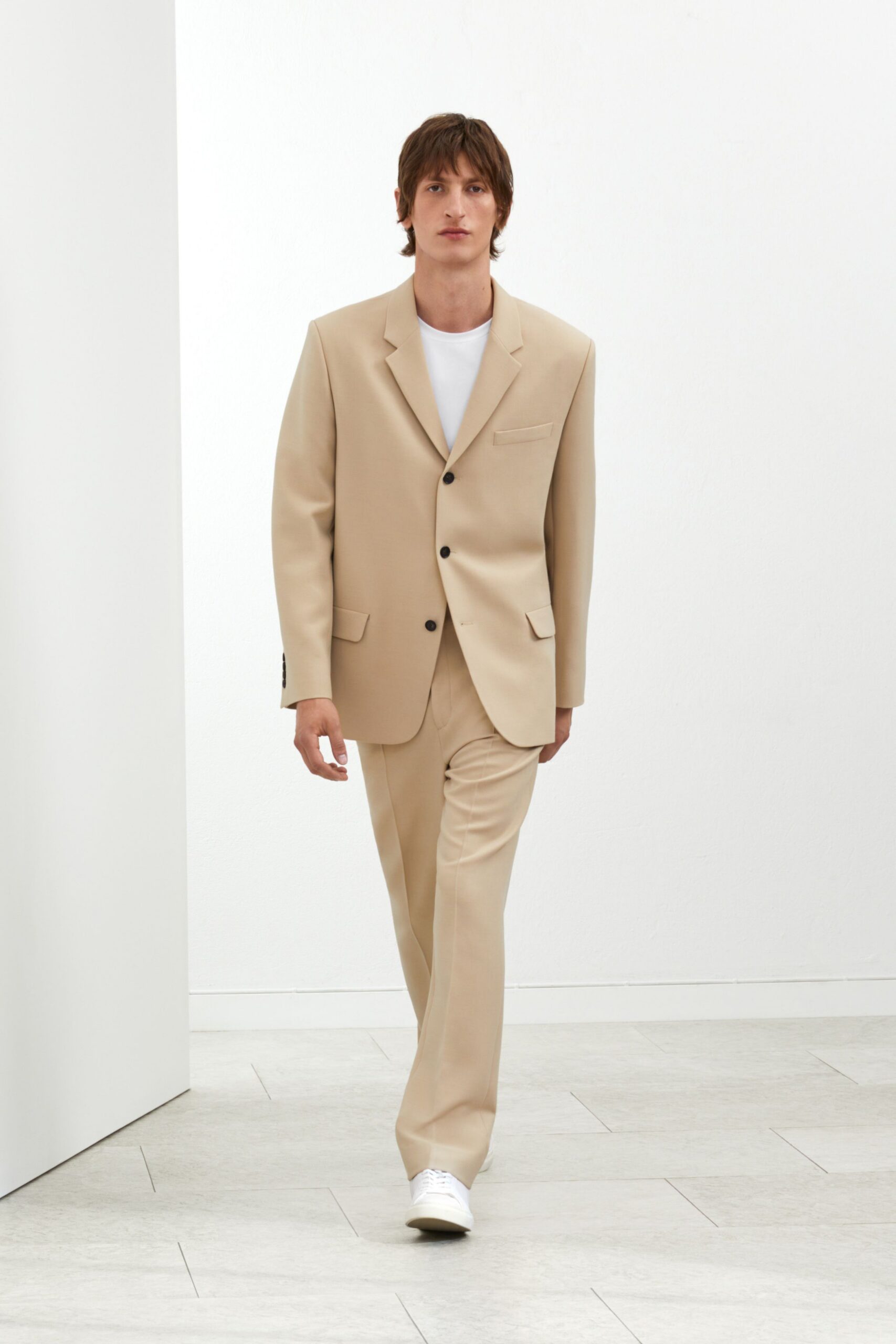 beige tailored suit with white t-shirt
