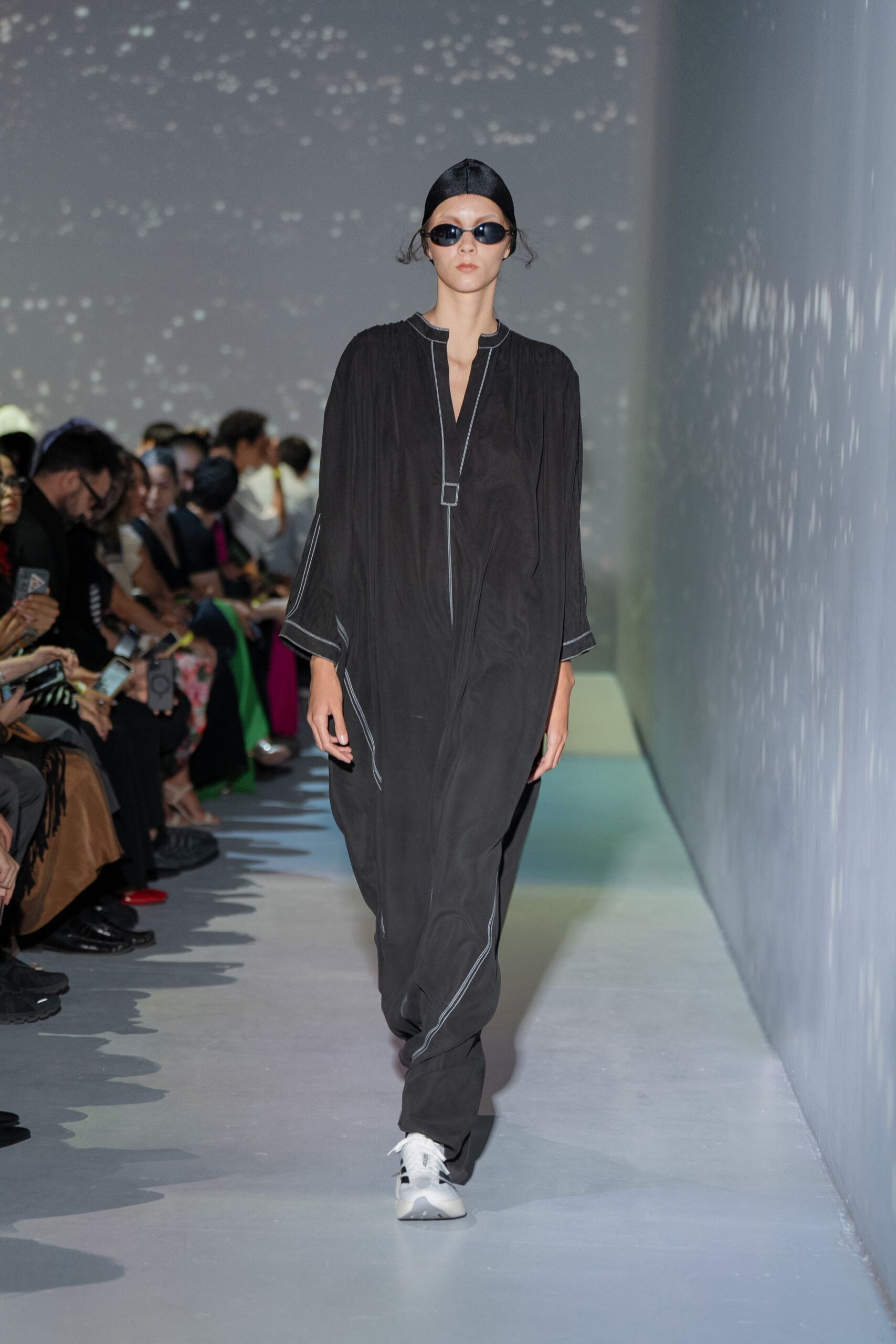 black relaxed jumpsuit with white shoes