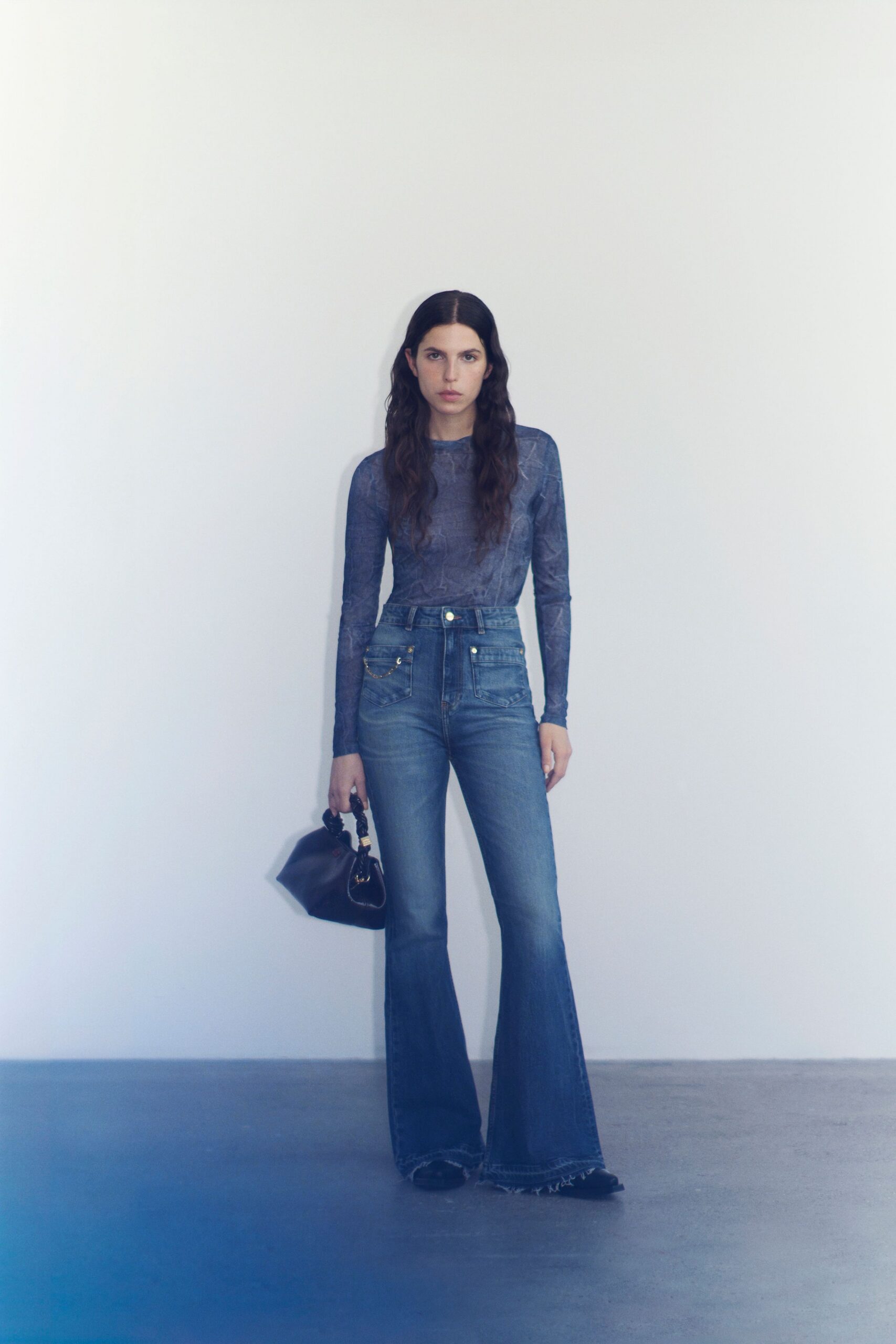 blue fitted top with flared jeans