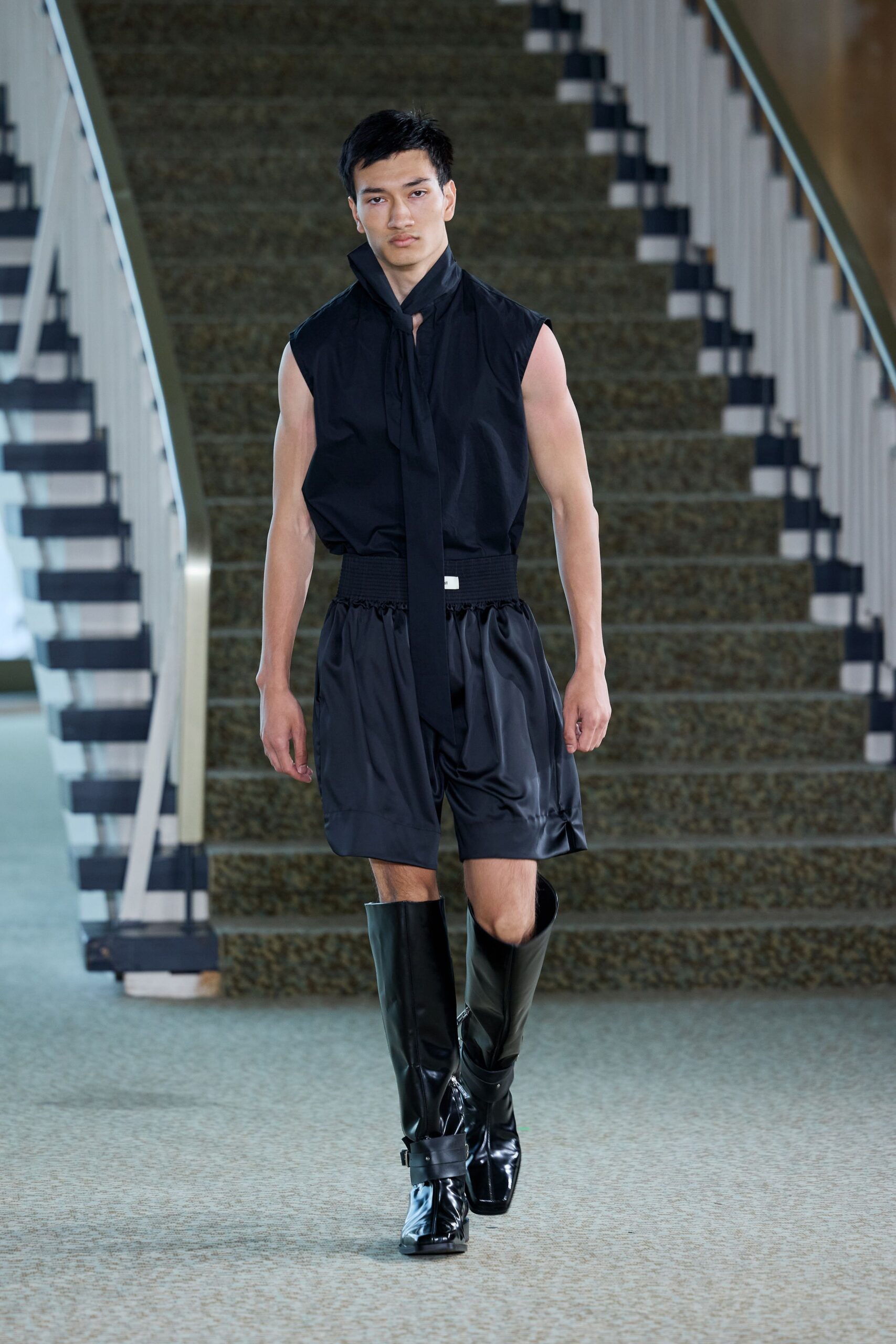 black fitted top and relaxed shorts with boots