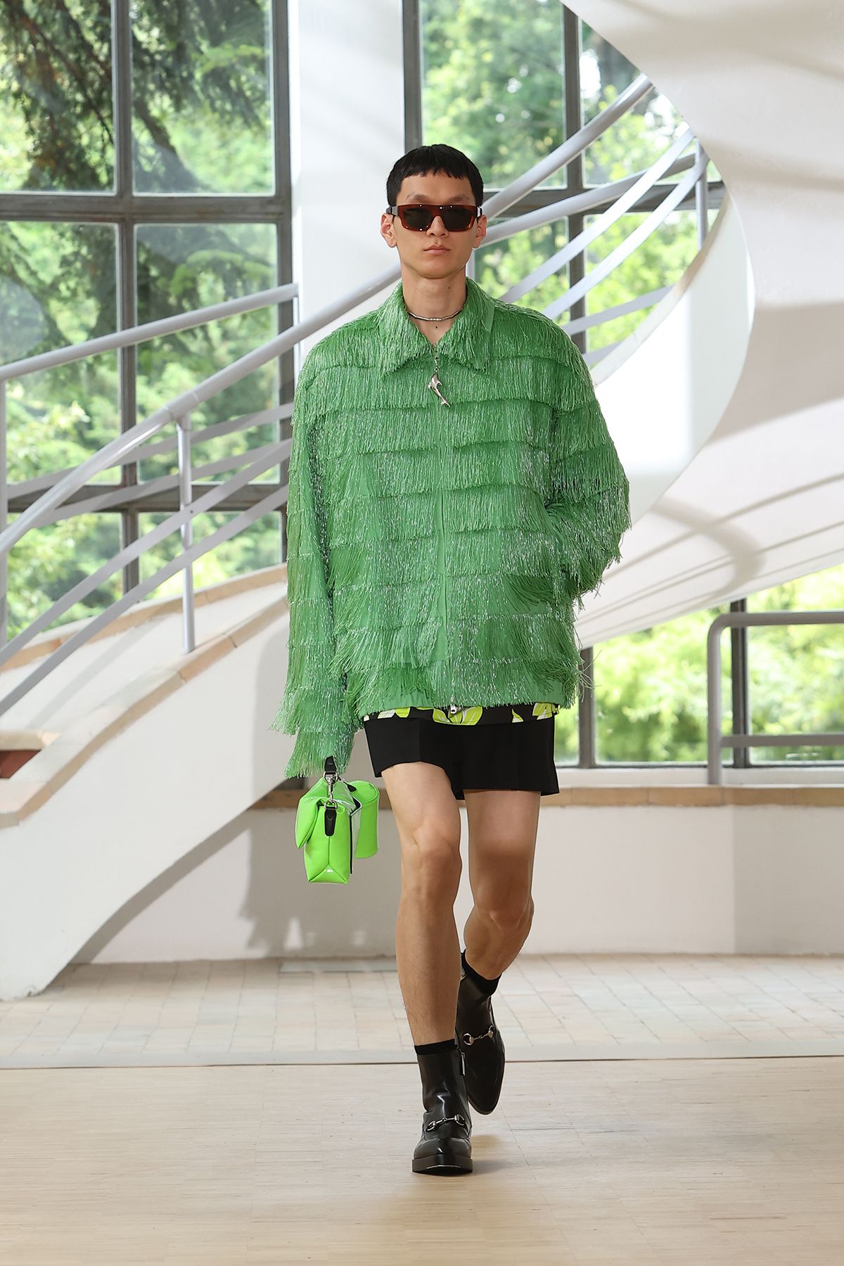 green fringed shirt with black shorts