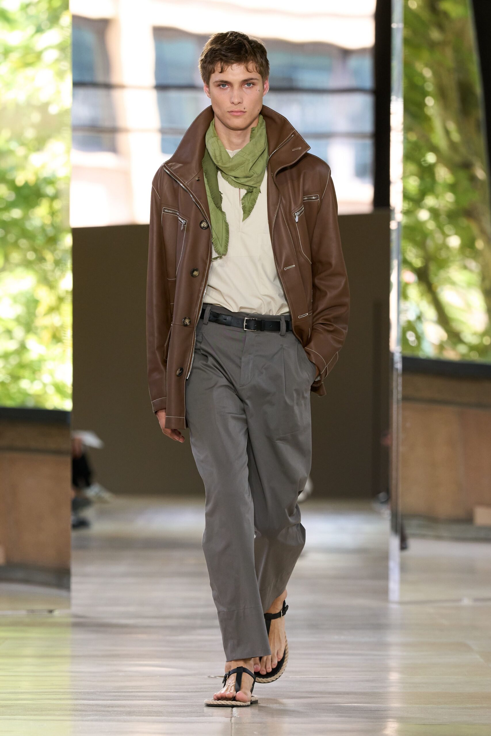 brown leather jacket with gray pants