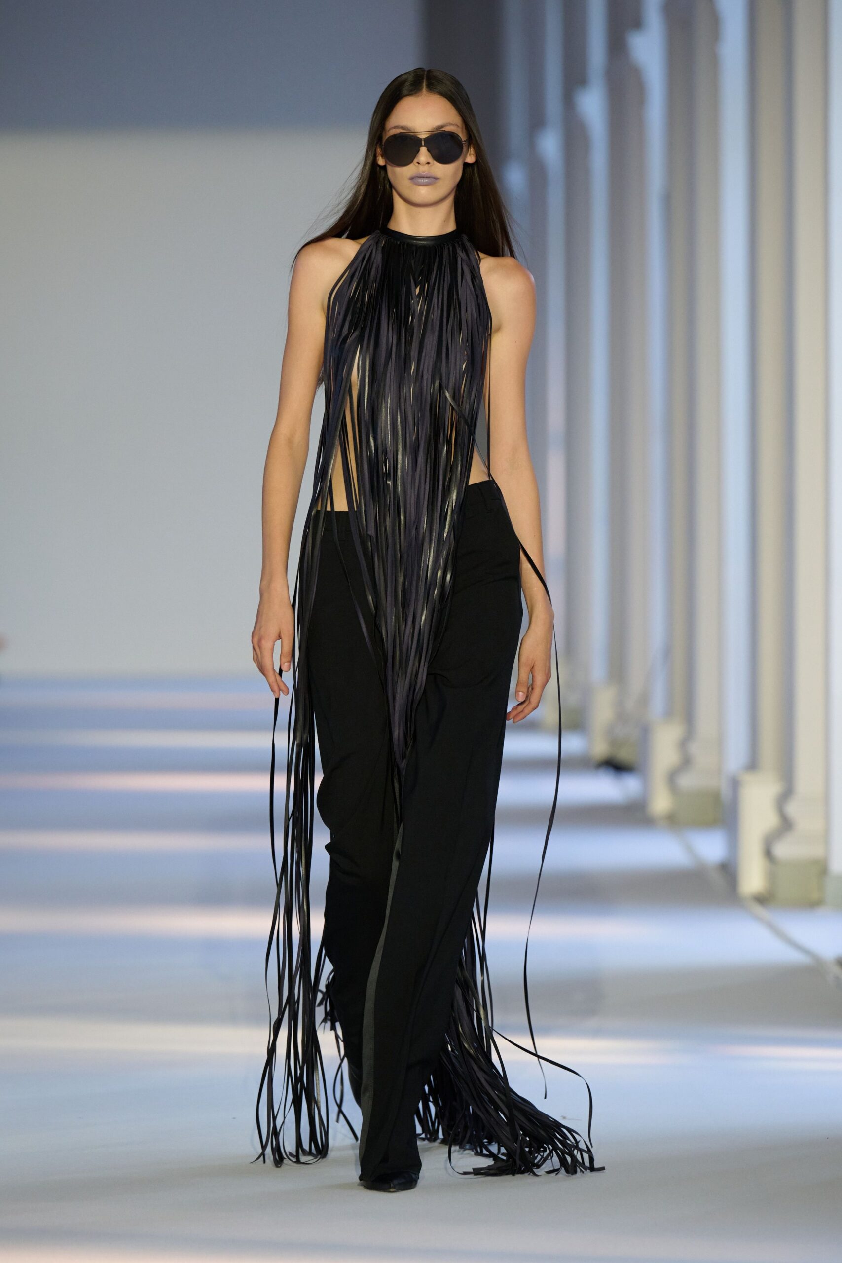 black fringed top with slim pants