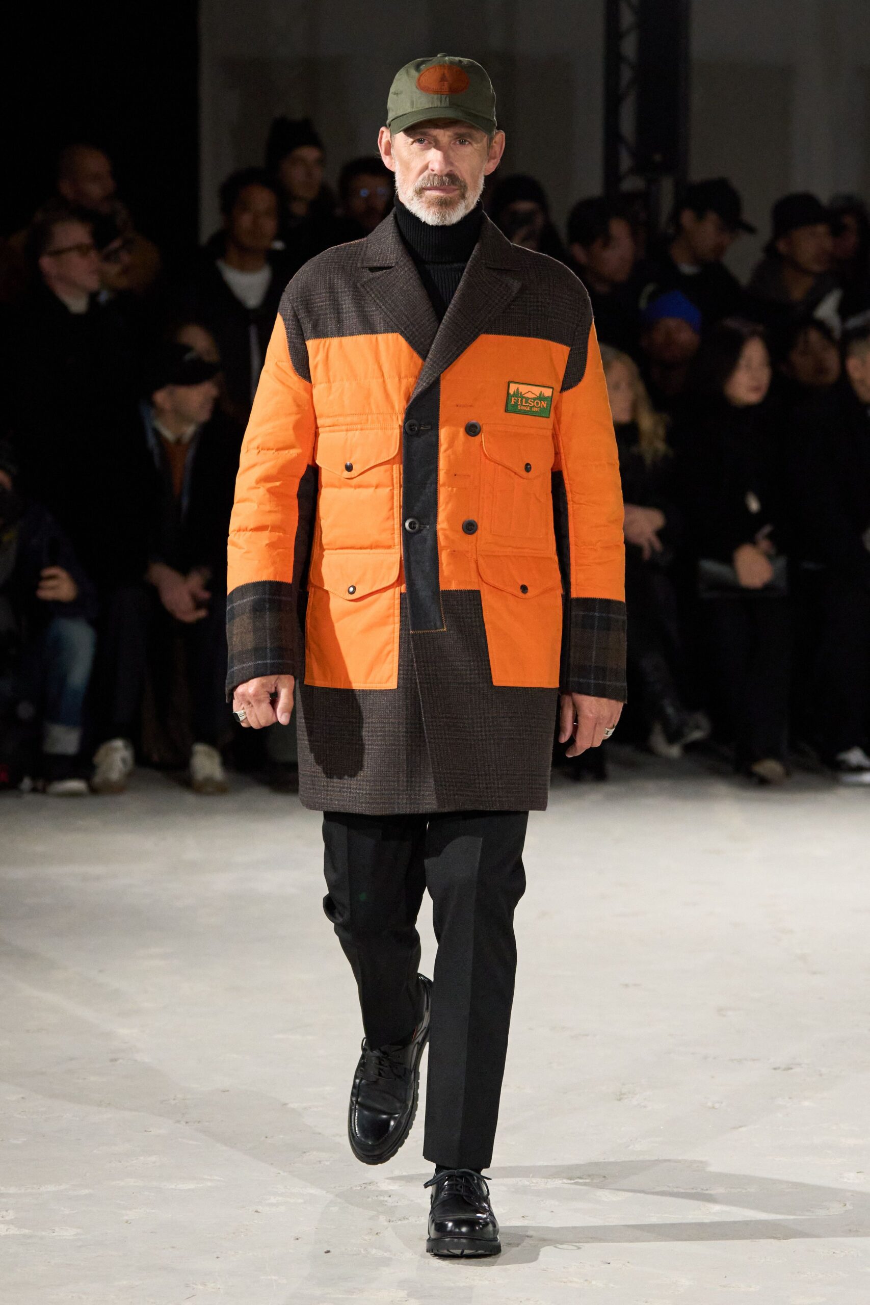 orange and brown coat with black pants