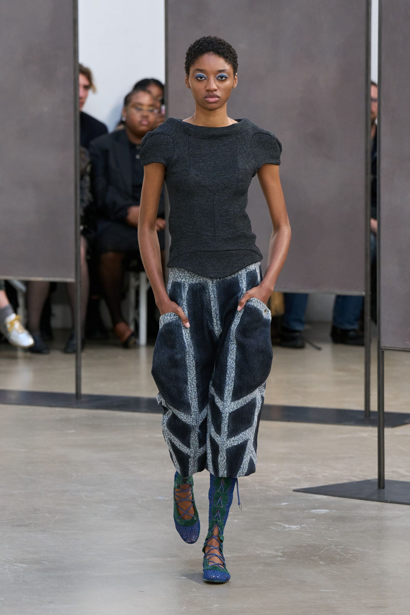 black fitted top with blue wide-leg pants