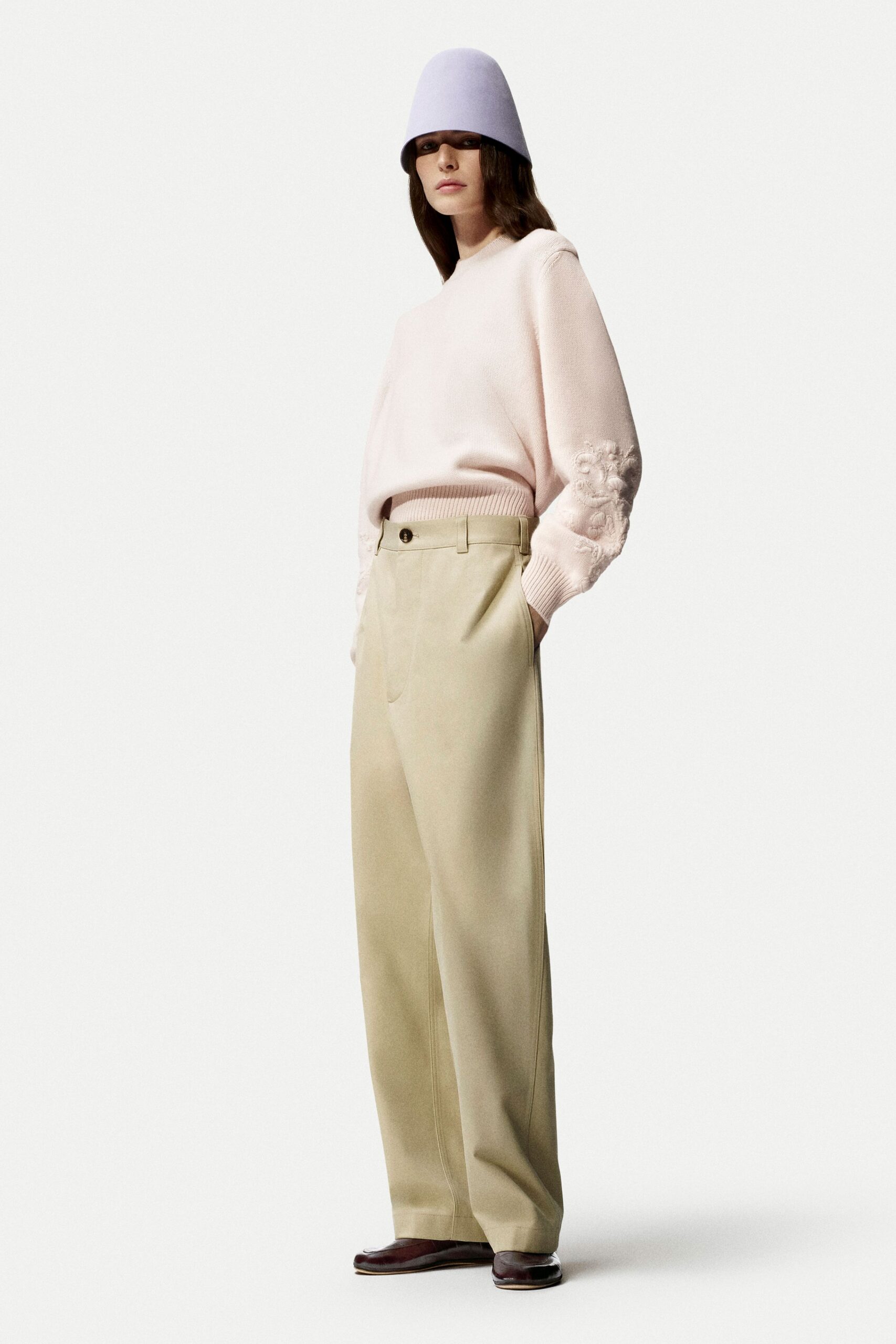 pink relaxed sweater with beige pants